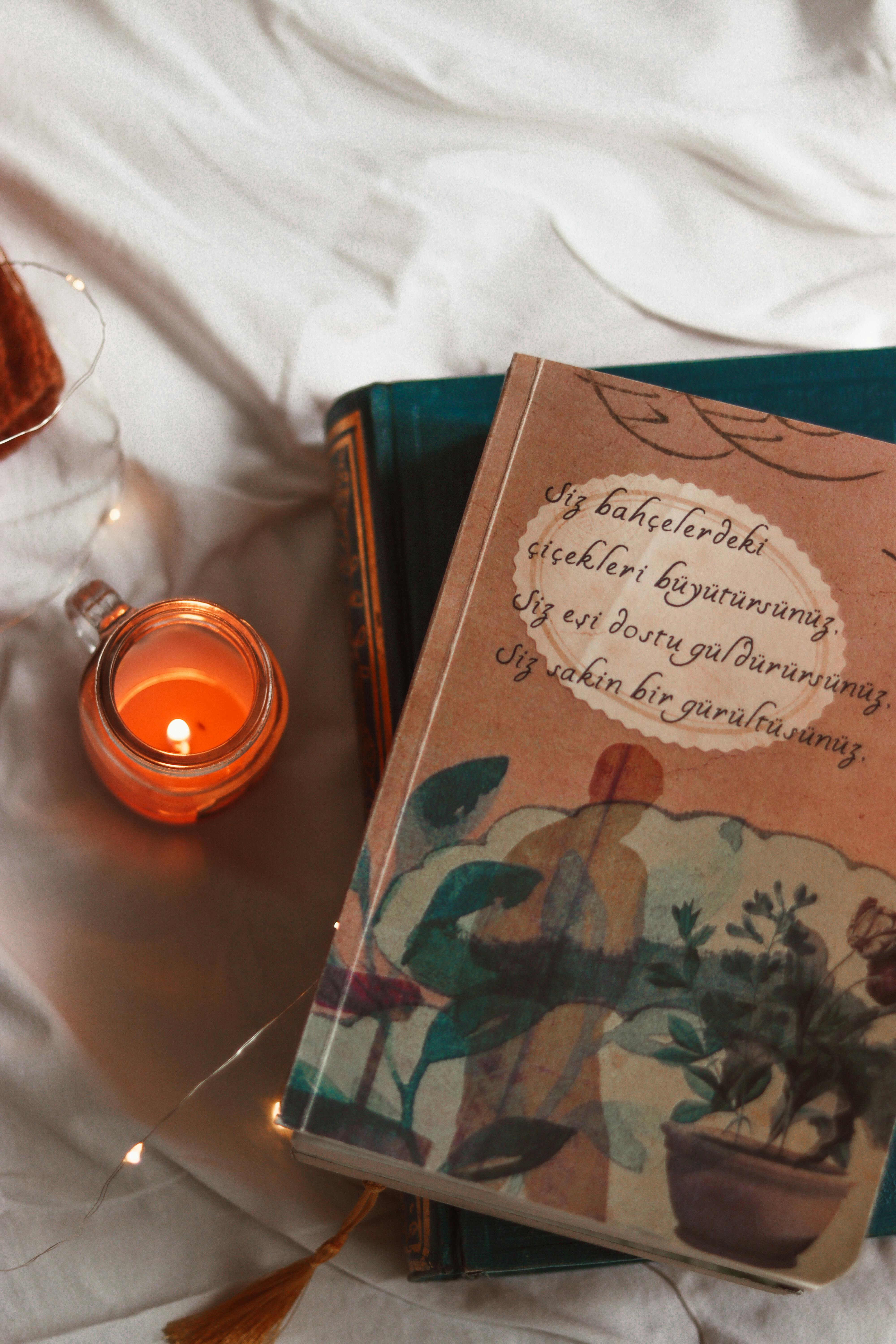 Cozy Reading Scene with Books and Candle