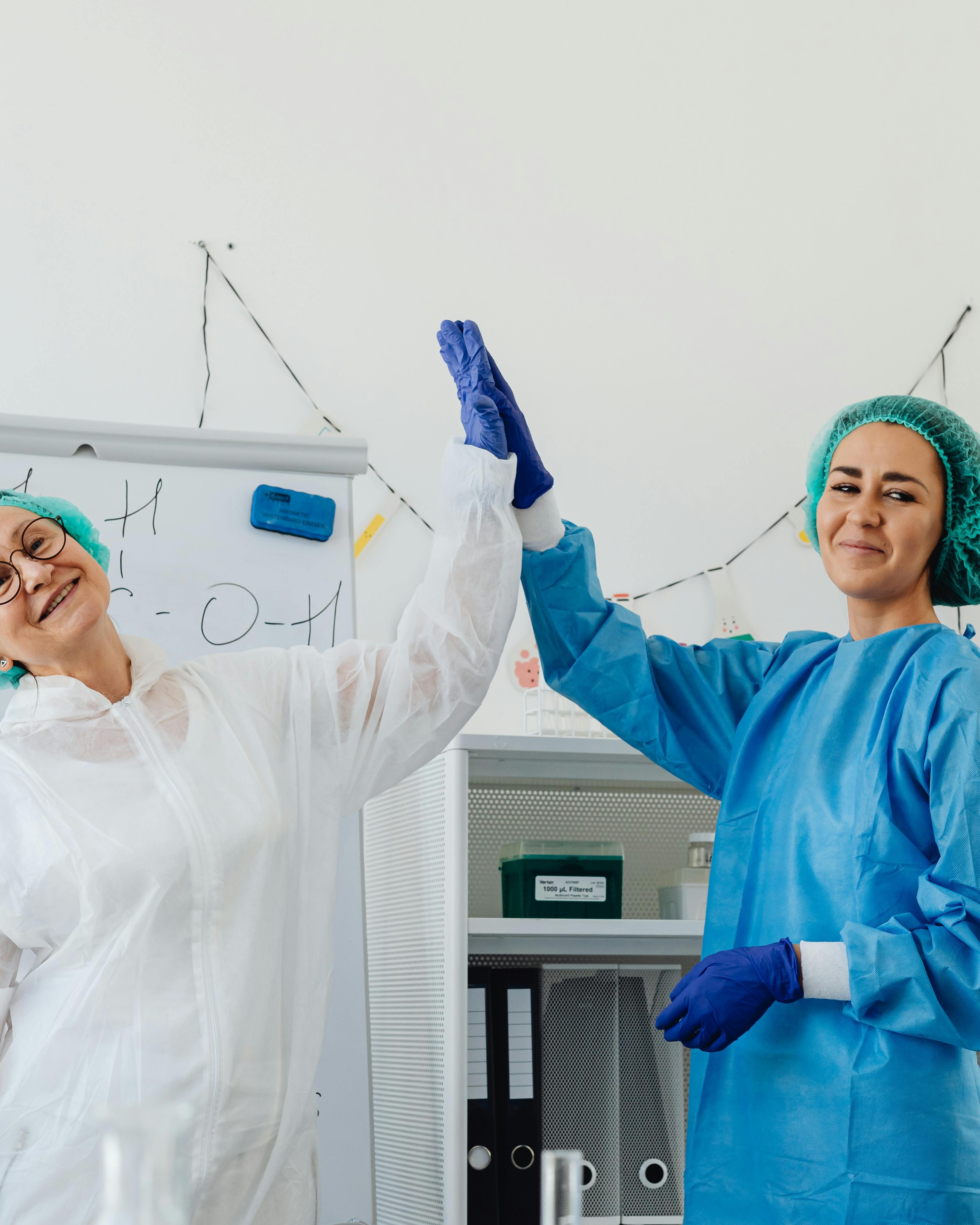 Two Lab Workers Celebratory High Five