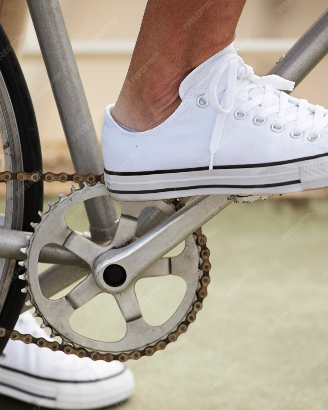 White Sneakers on Bicycle Pedal