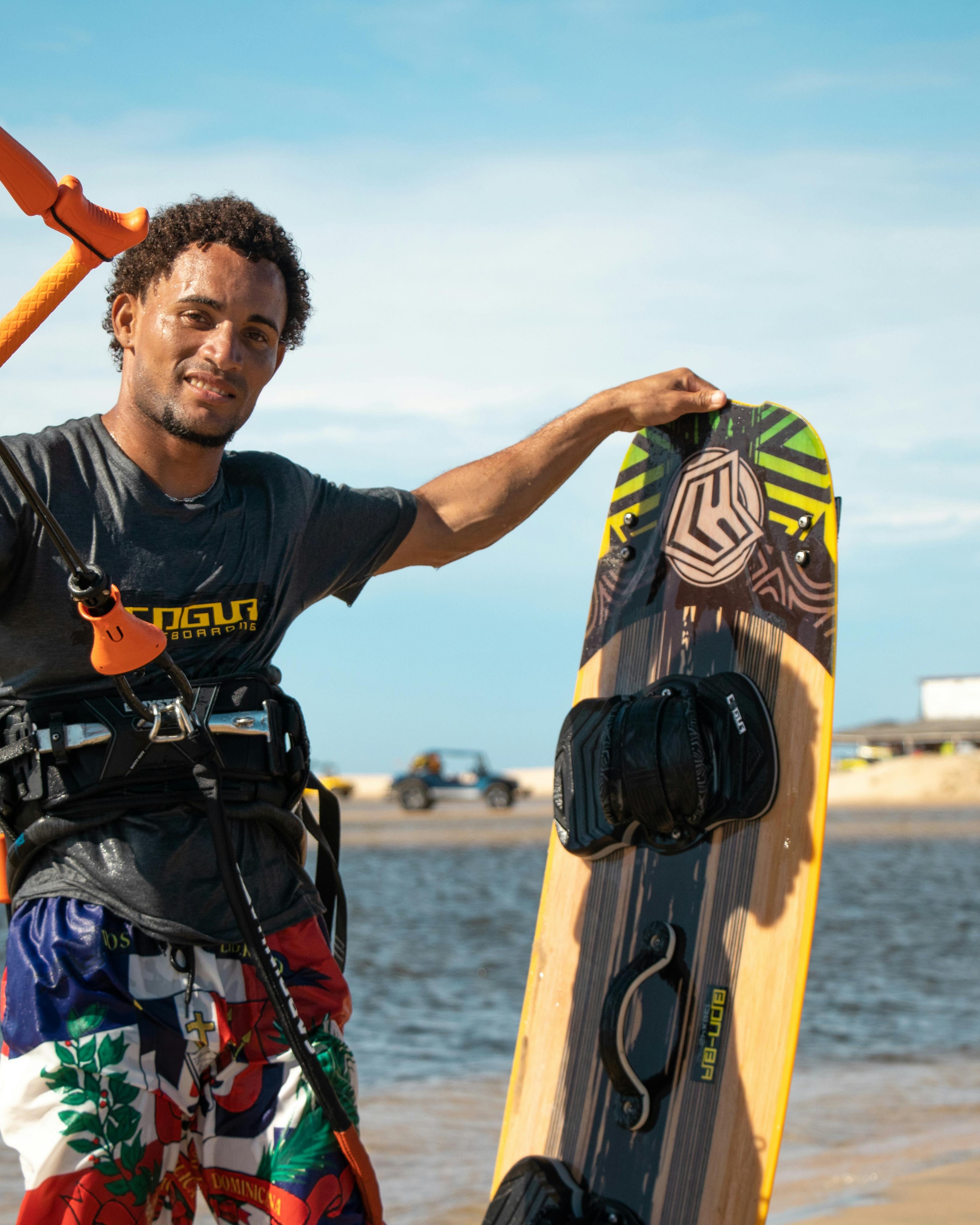 Kiteboarder Holding Board At Beach