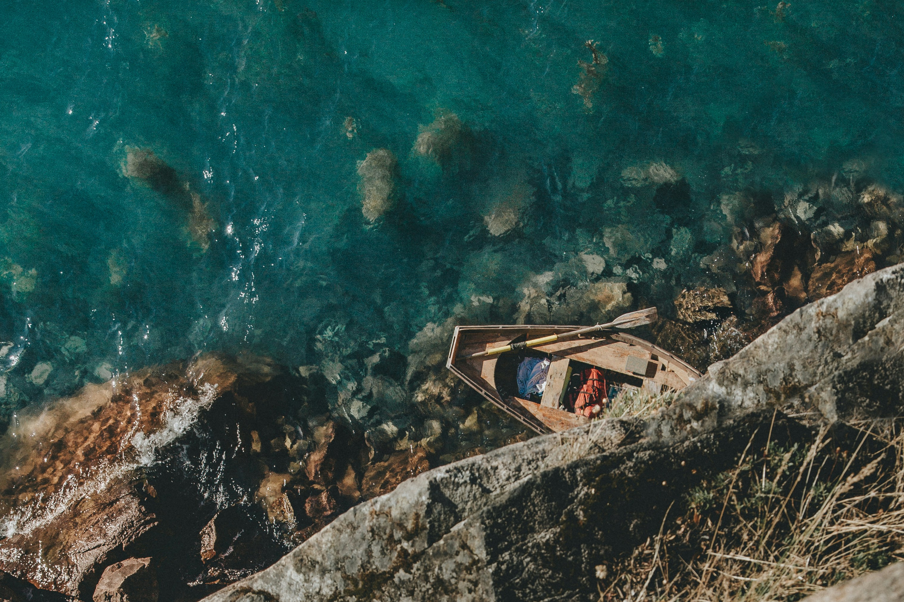Small Wooden Boat on Clear Turquoise Water