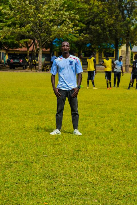 Man Standing on Grassy Soccer Field
