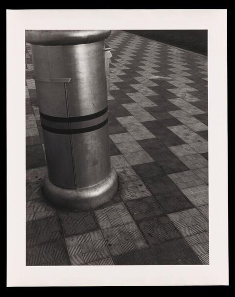 Metal Bollard on Checkered Pavement