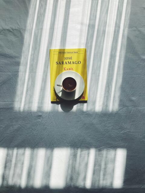 Book and Coffee With Striped Window Shadows