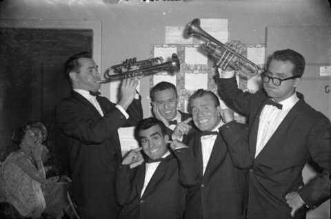 Five Men in Tuxedos Posing With Trumpets