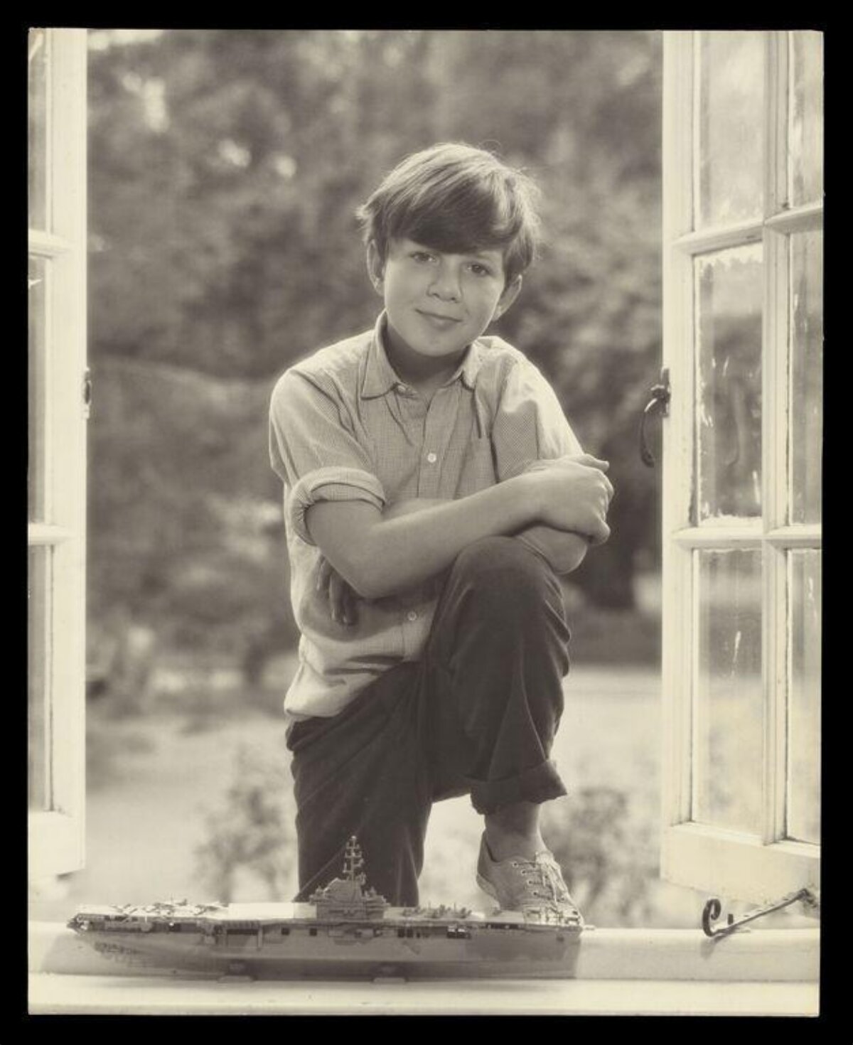 Boy with Model Aircraft Carrier by Window