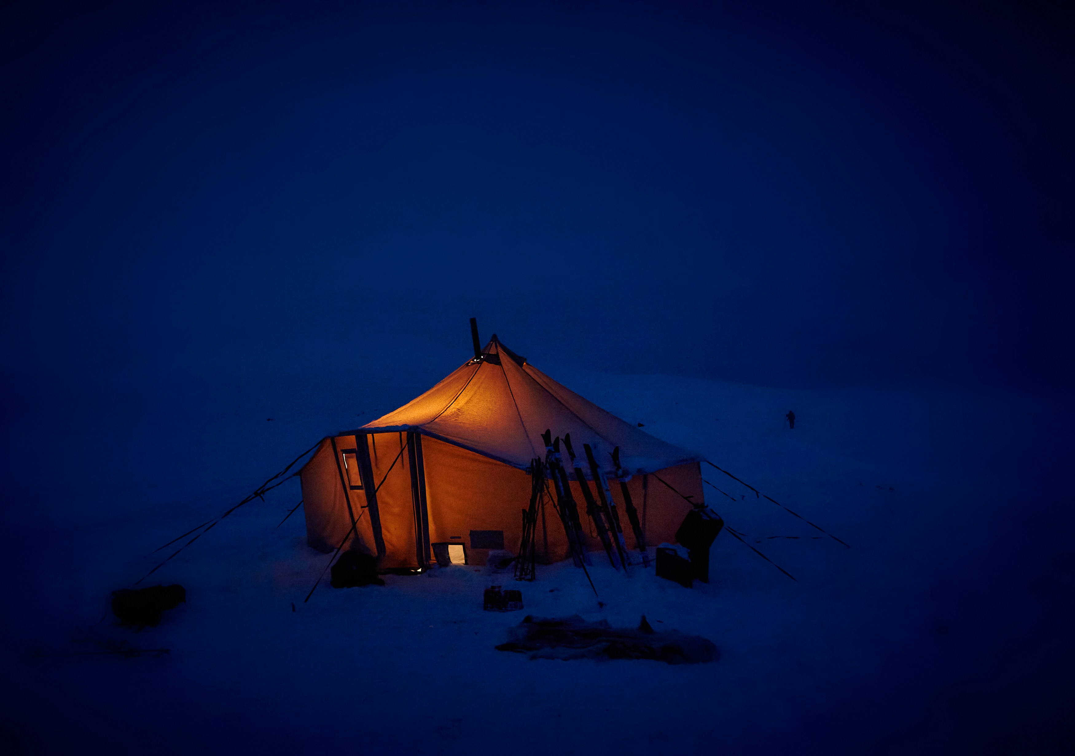 Lit Tent on Snowy Night