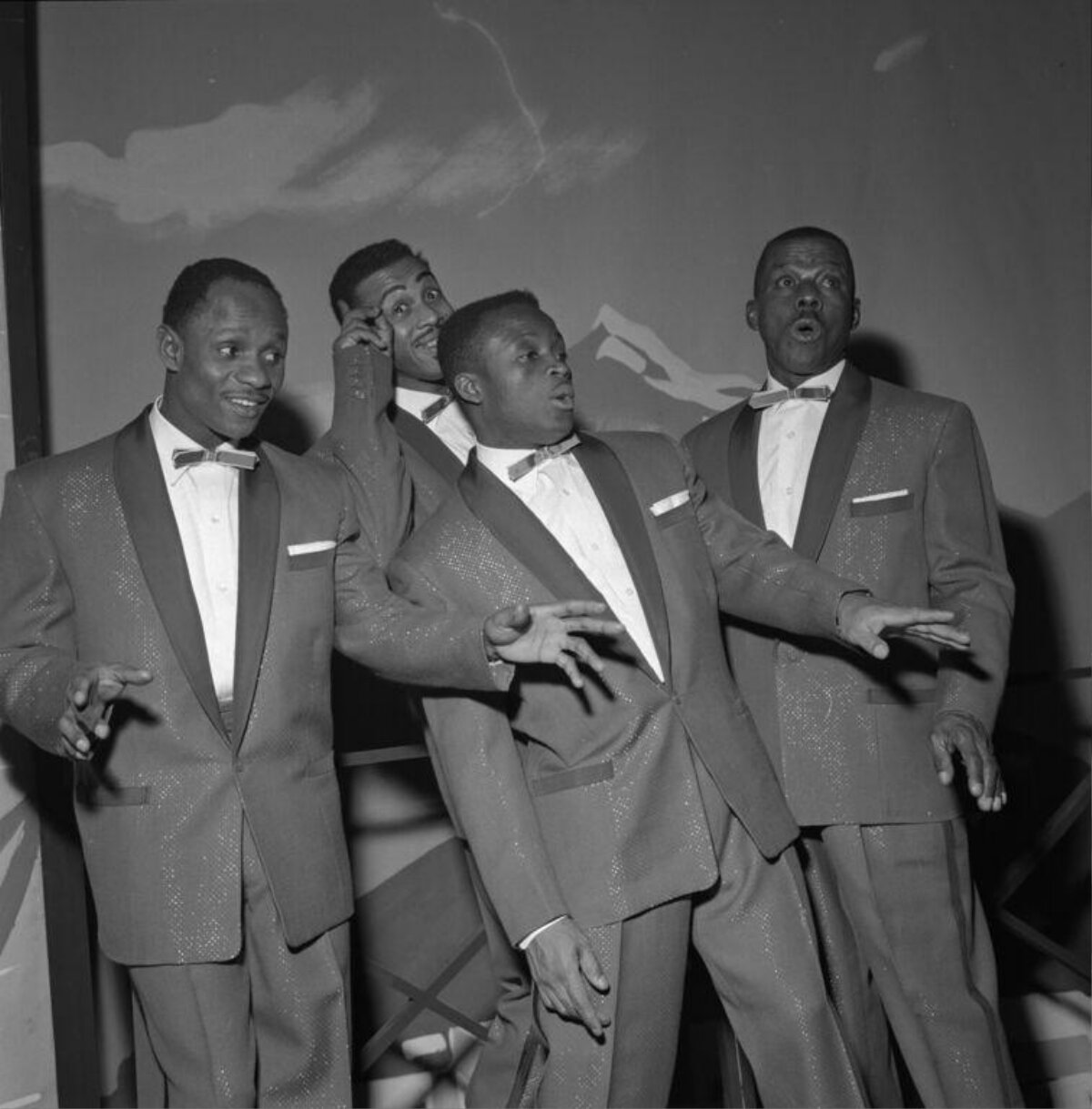Four Male Singers Performing On Stage