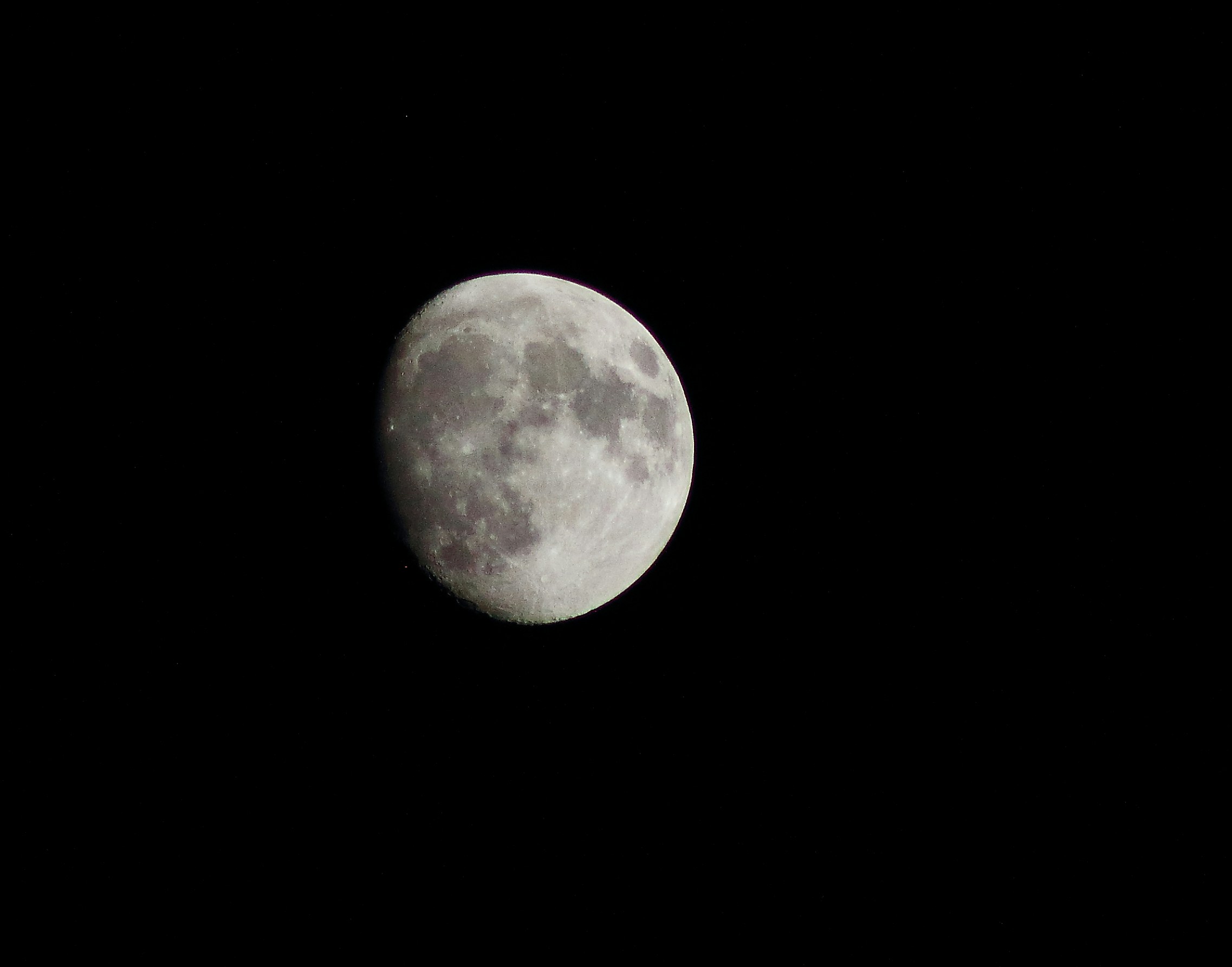 Gibbous Moon Against Black Night Sky