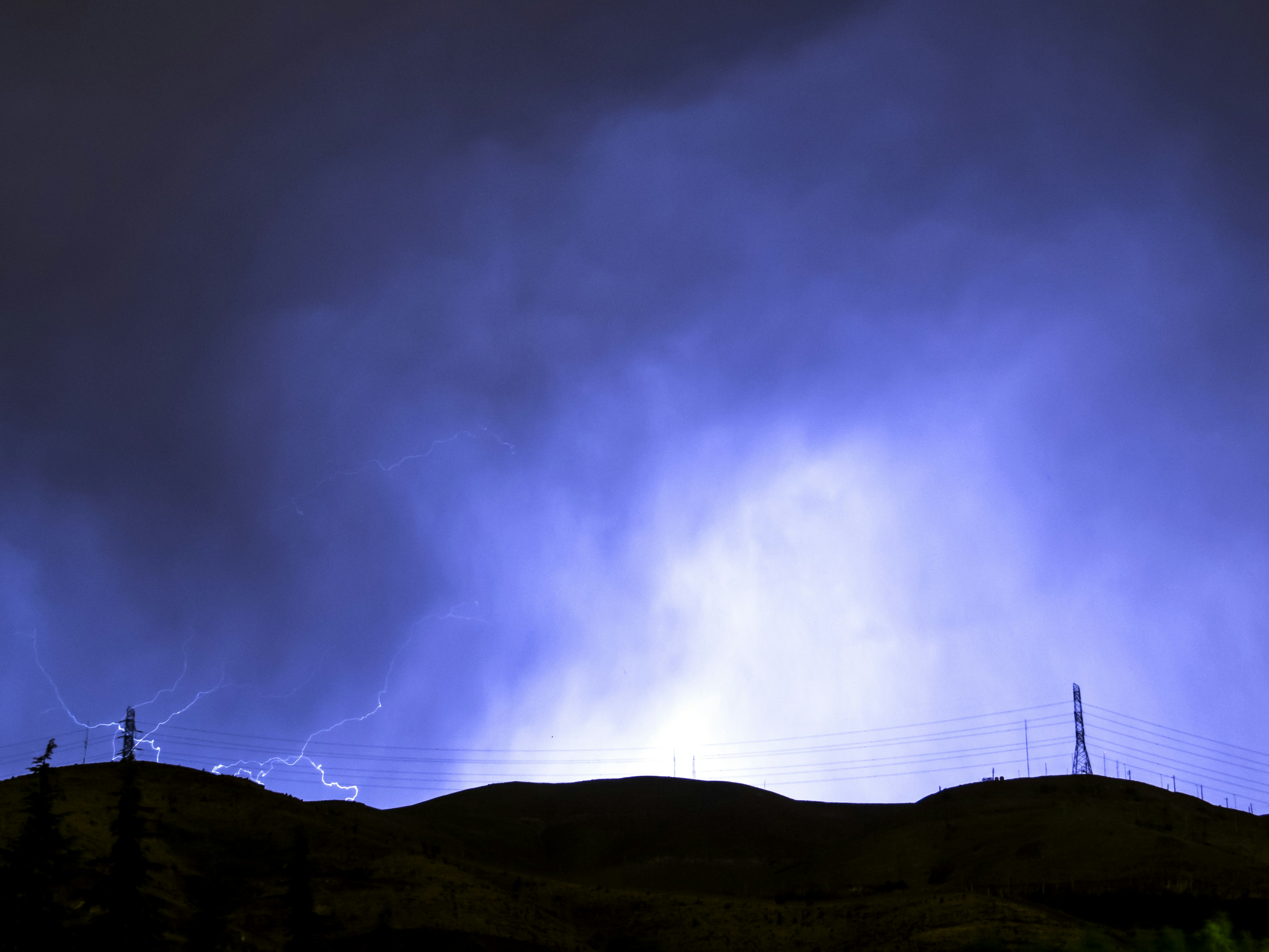 Night Lightning Over Hilltop Power Lines