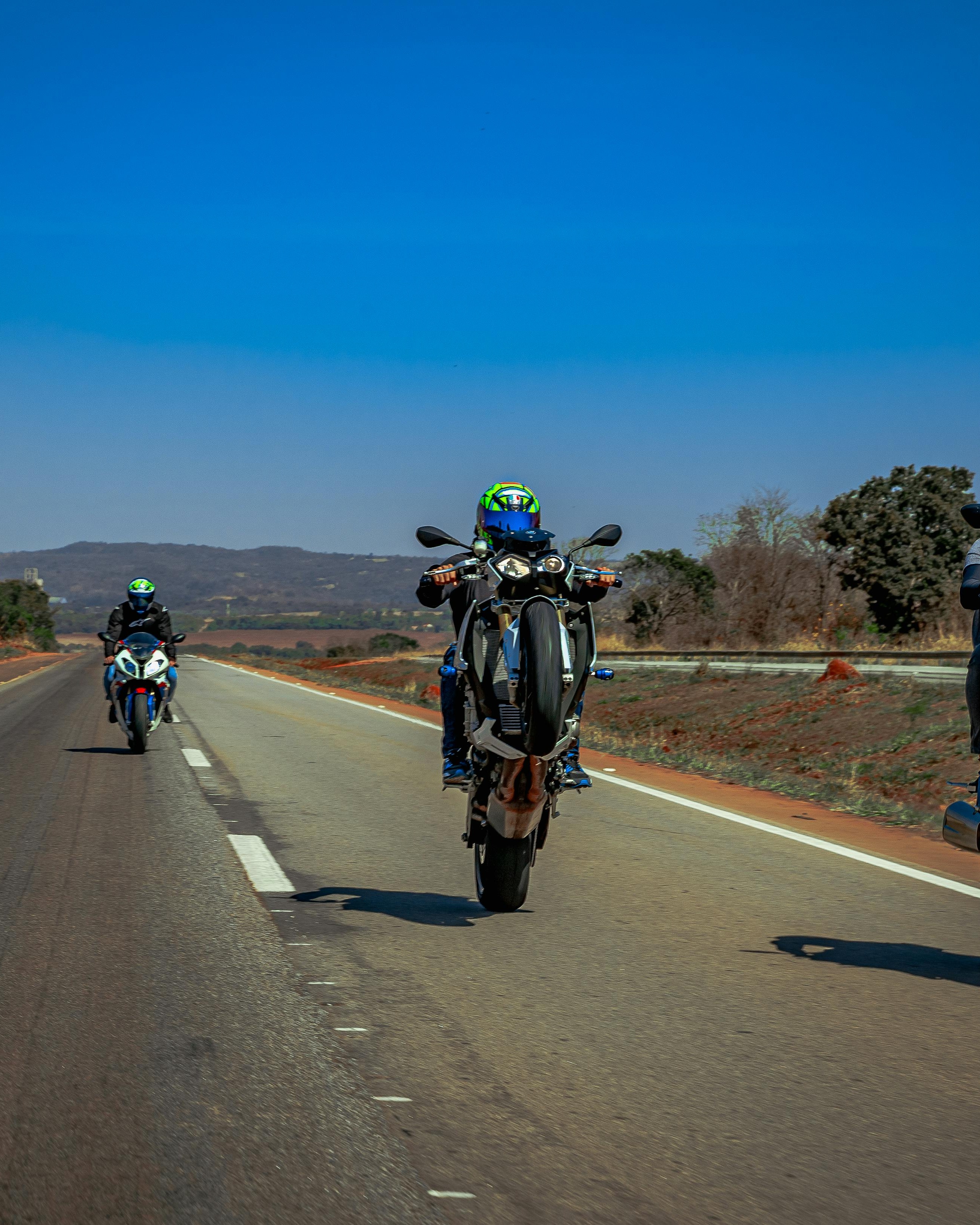 Motorcyclist Doing Wheelie on Open Highway