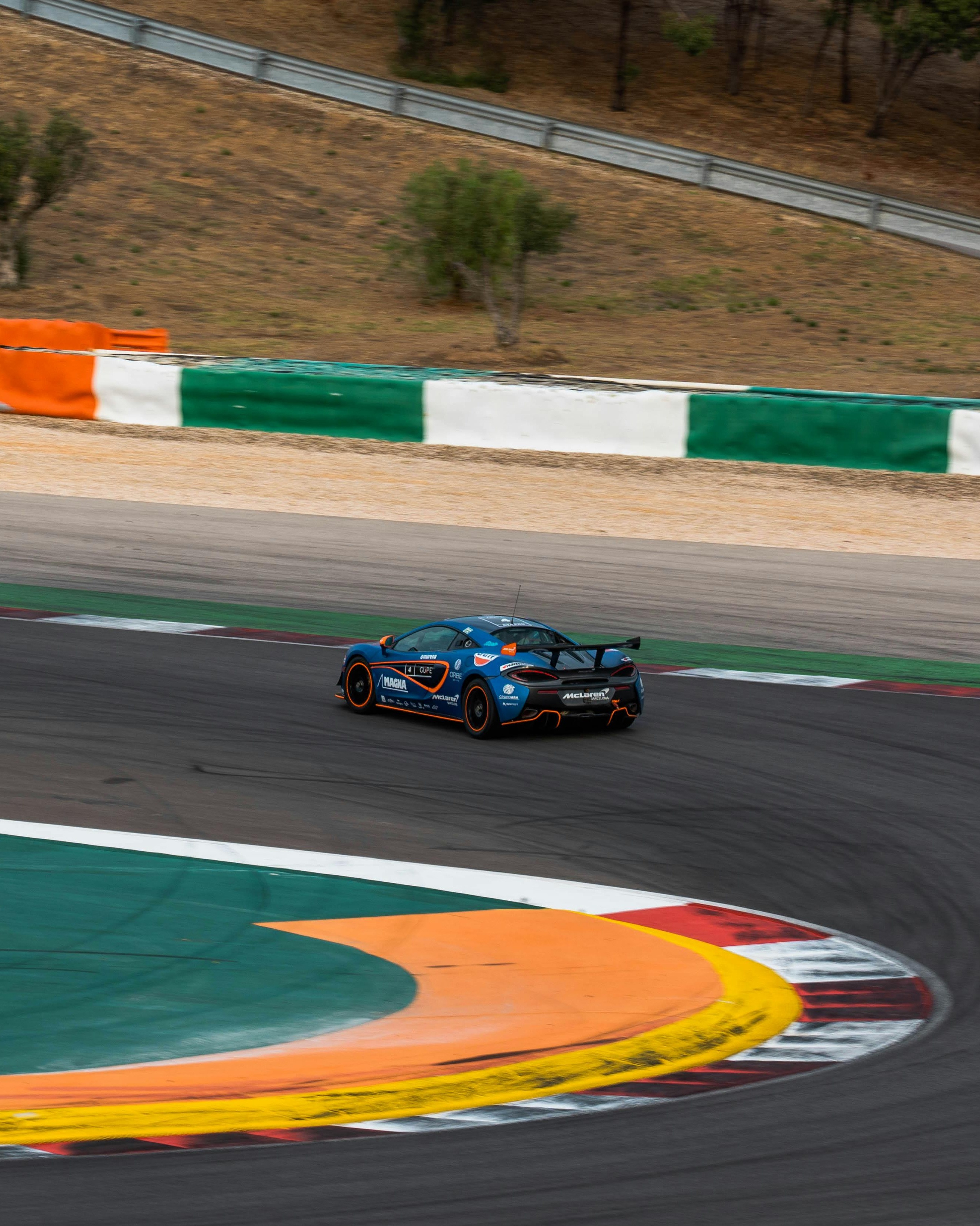 Blue McLaren Race Car on Racetrack