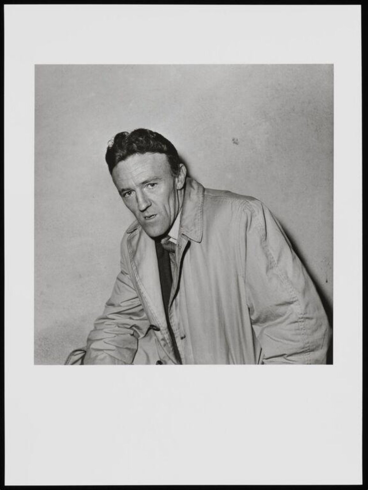Black and White Portrait of Man in Trench Coat