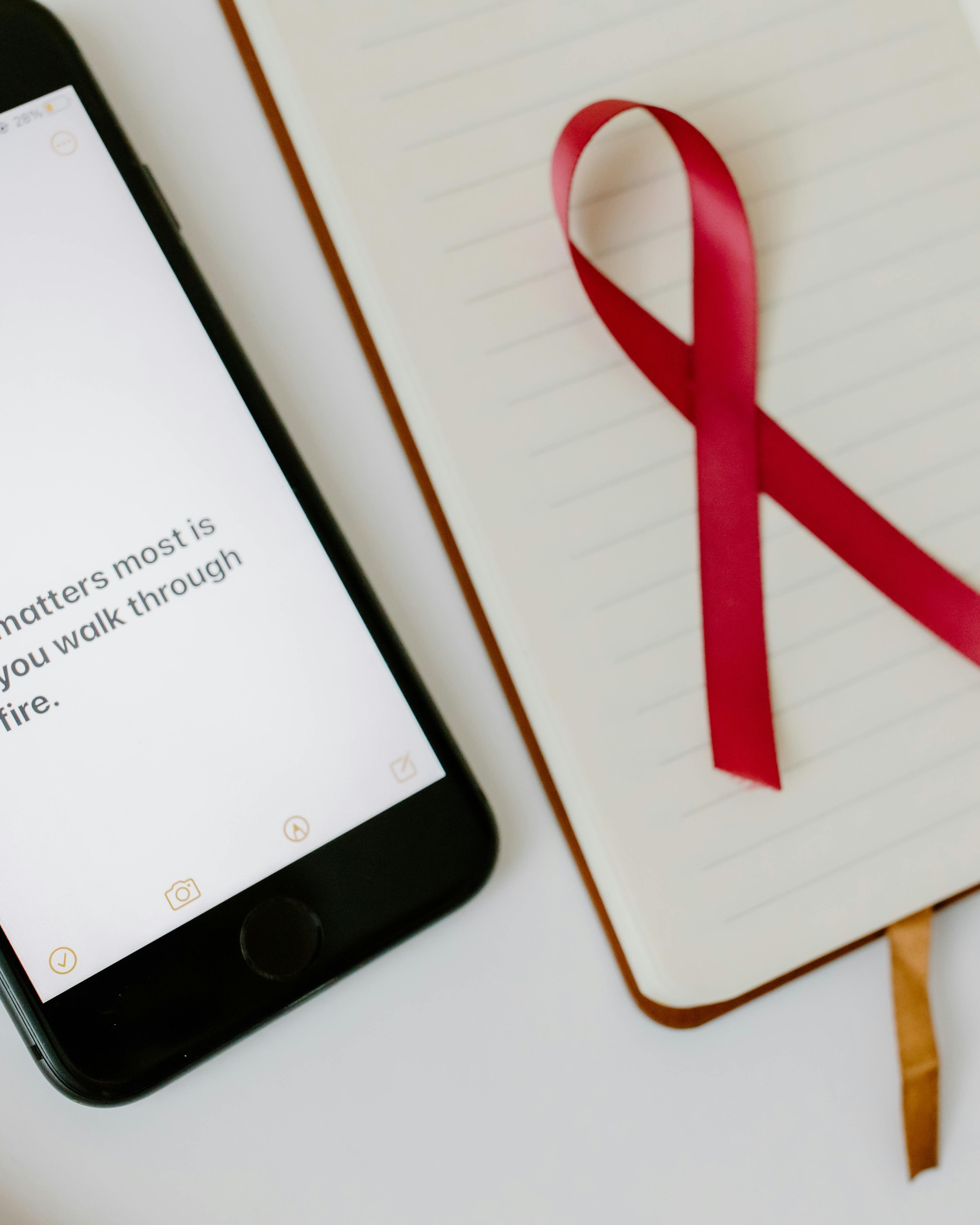 Red Awareness Ribbon with Notebook and Phone