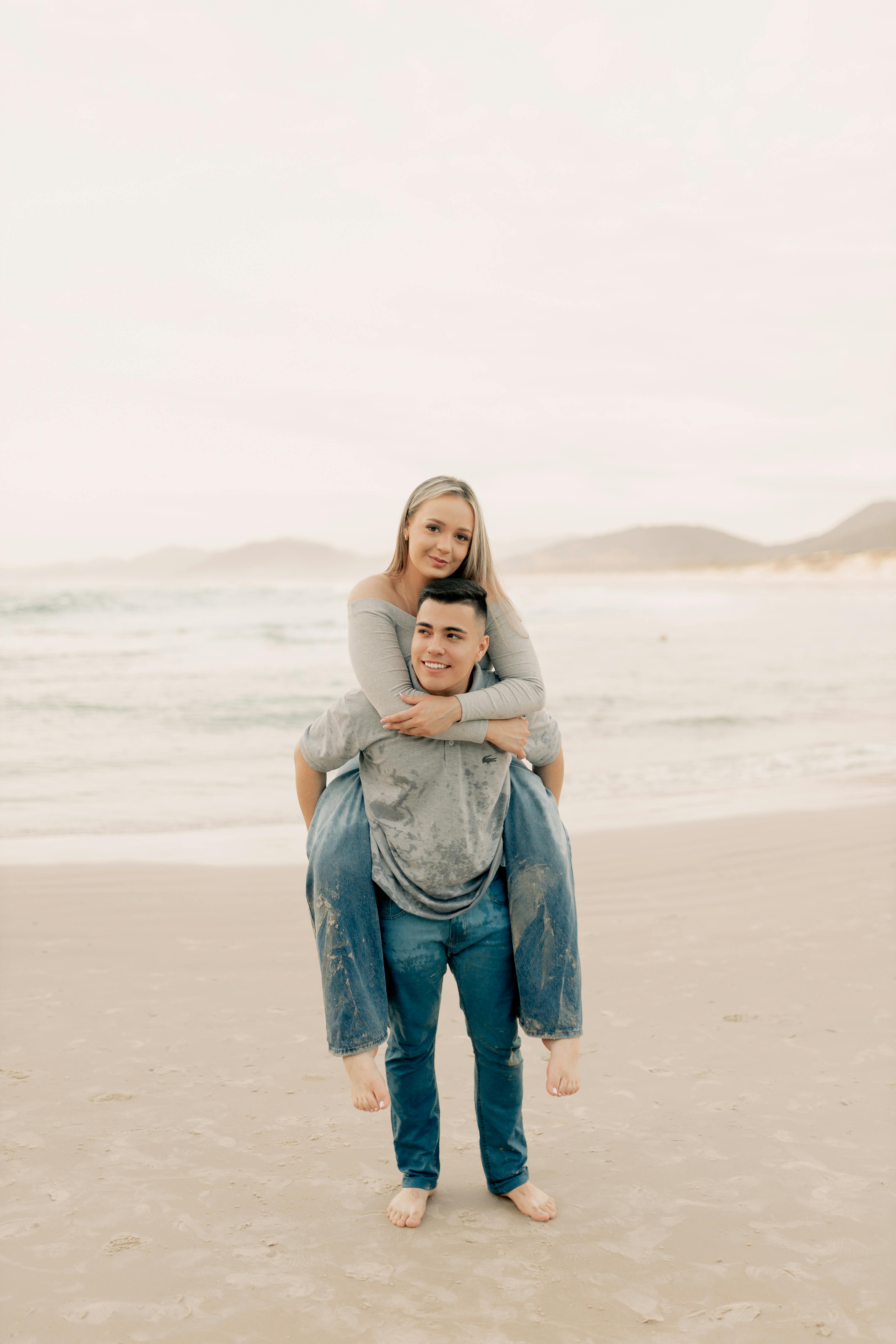 Couple Piggyback Ride on Beach