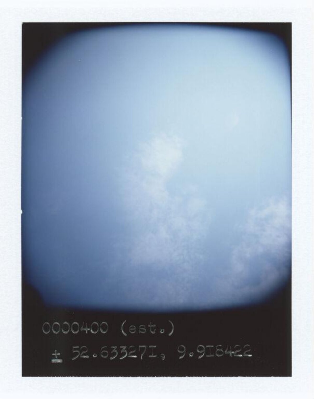 Polaroid Shot of Blue Sky with Coordinates