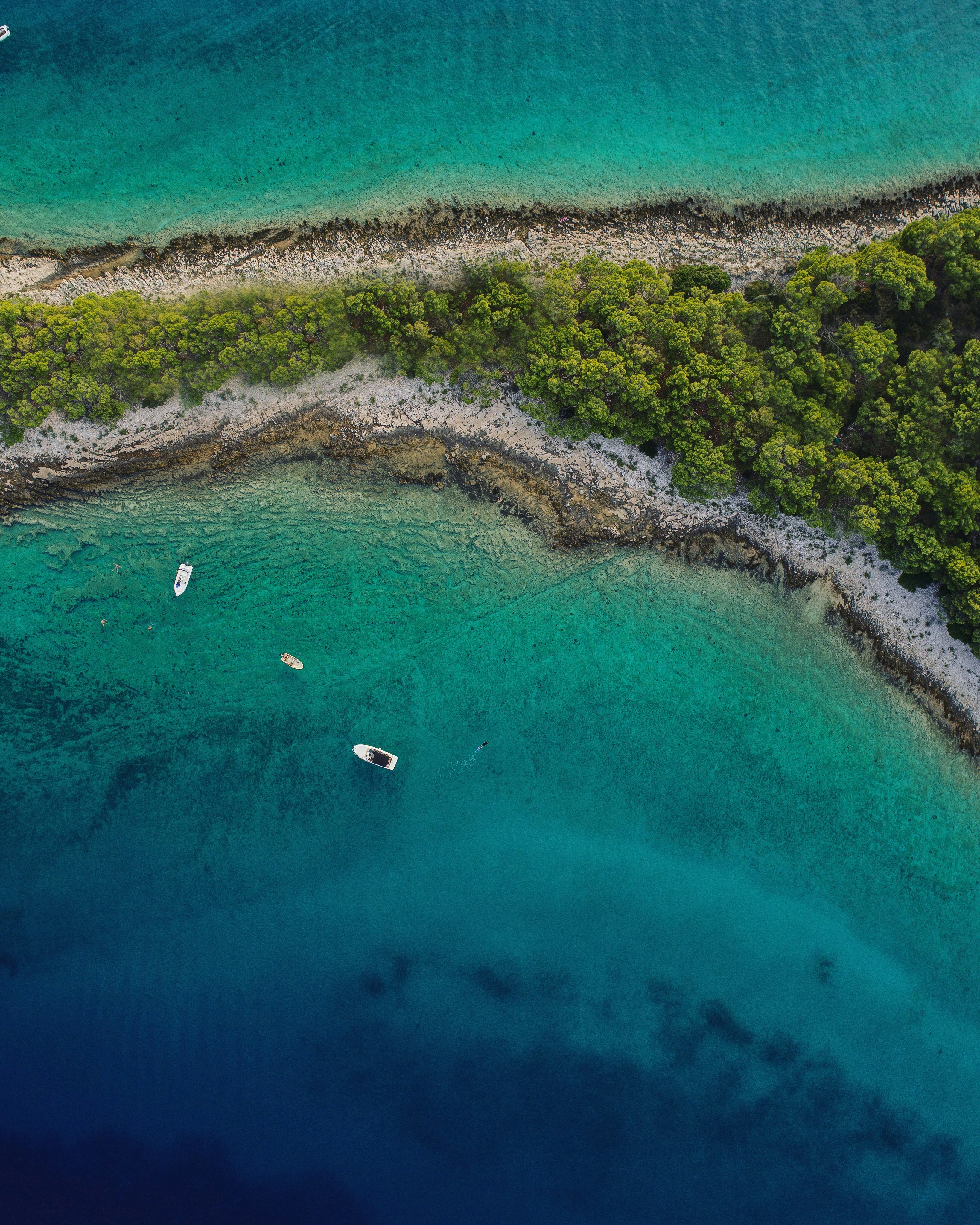 Aerial View of Coastal Cove with Anchored Boats