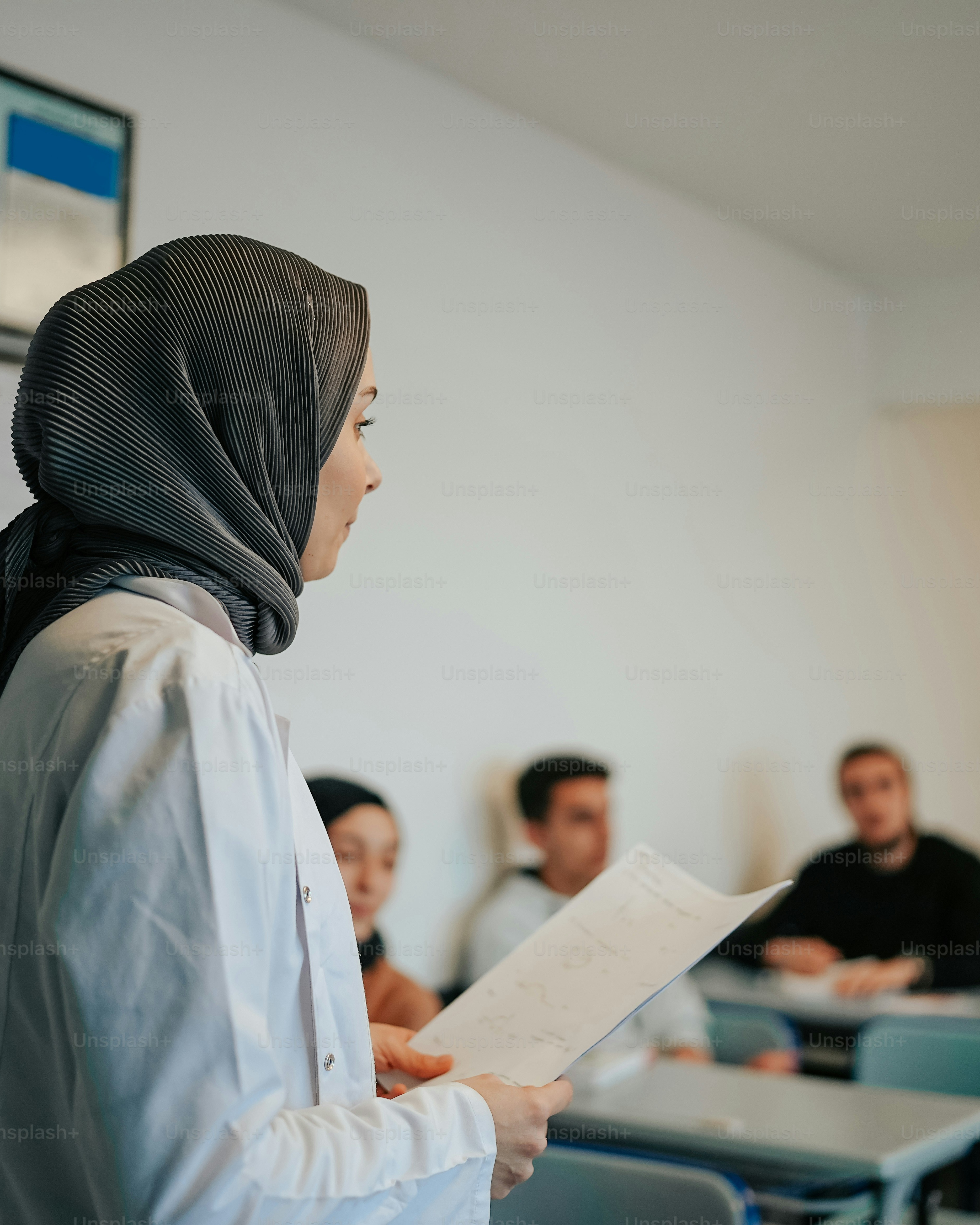 Muslim Student Presenting in Classroom