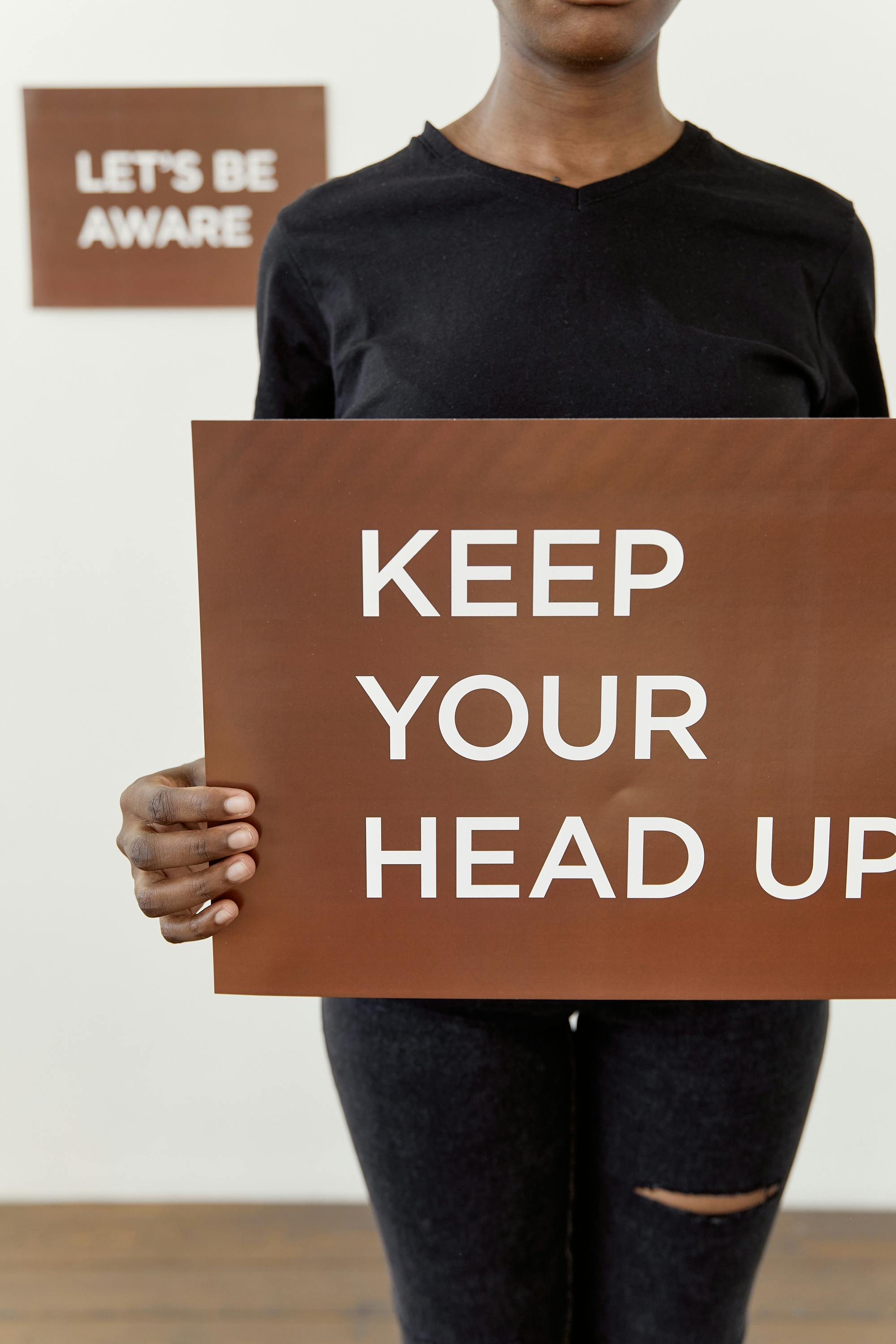 Person Holding Motivational Awareness Sign