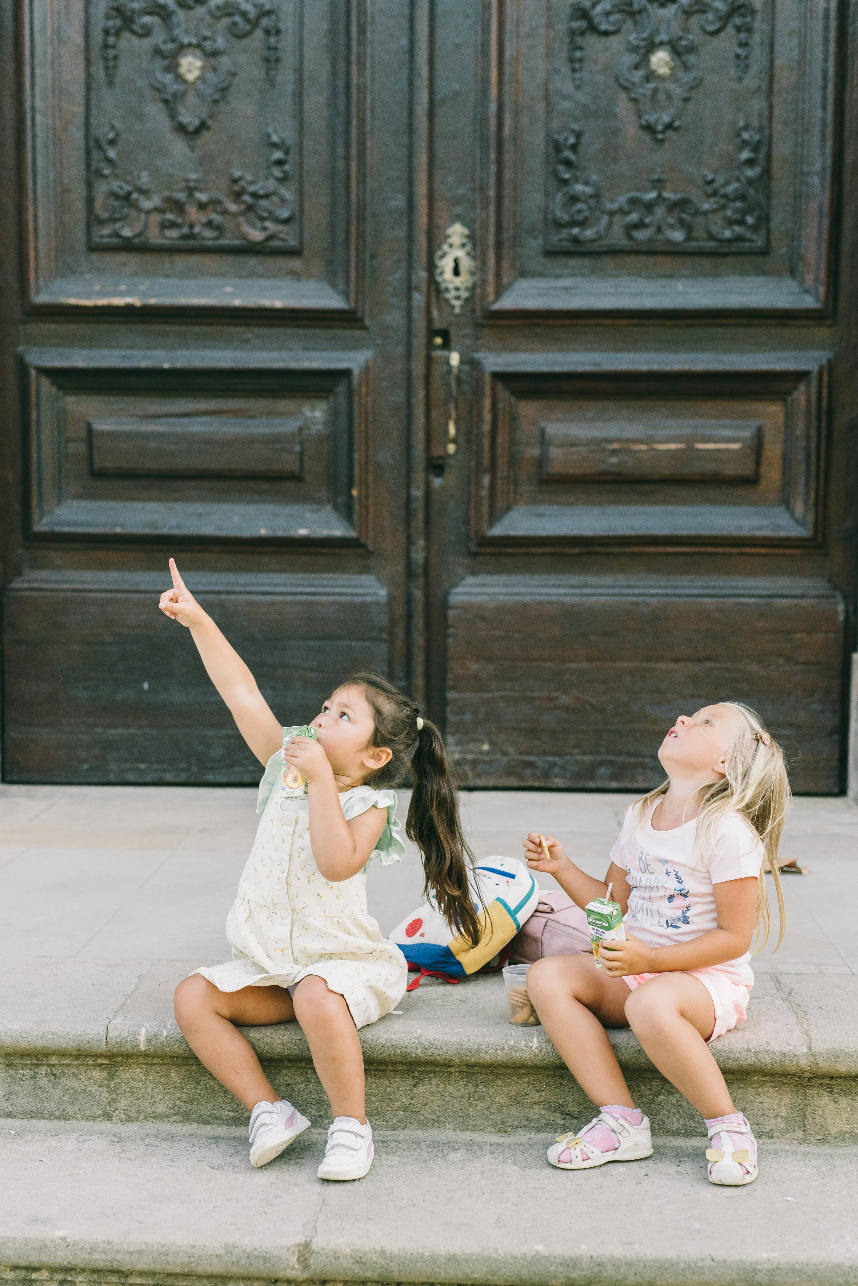 Two Girls Looking Up on Stone Steps