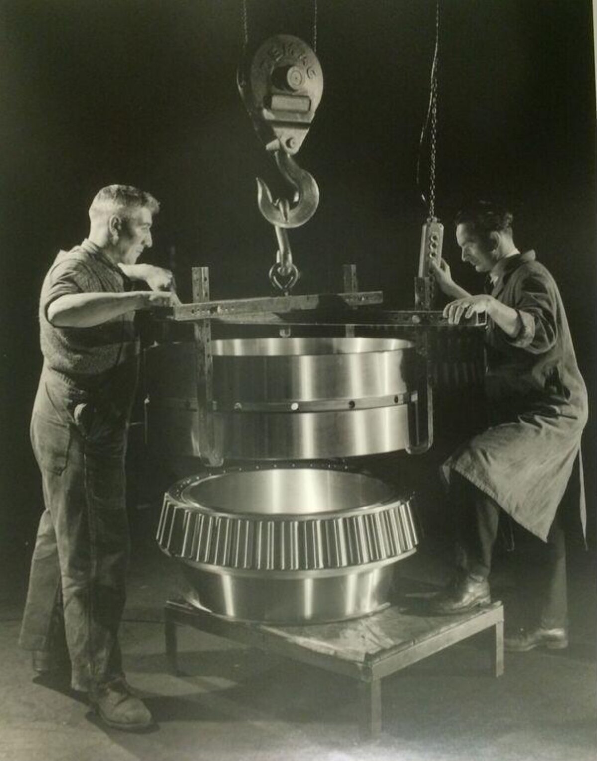 Two Workers Assembling Large Industrial Bearing