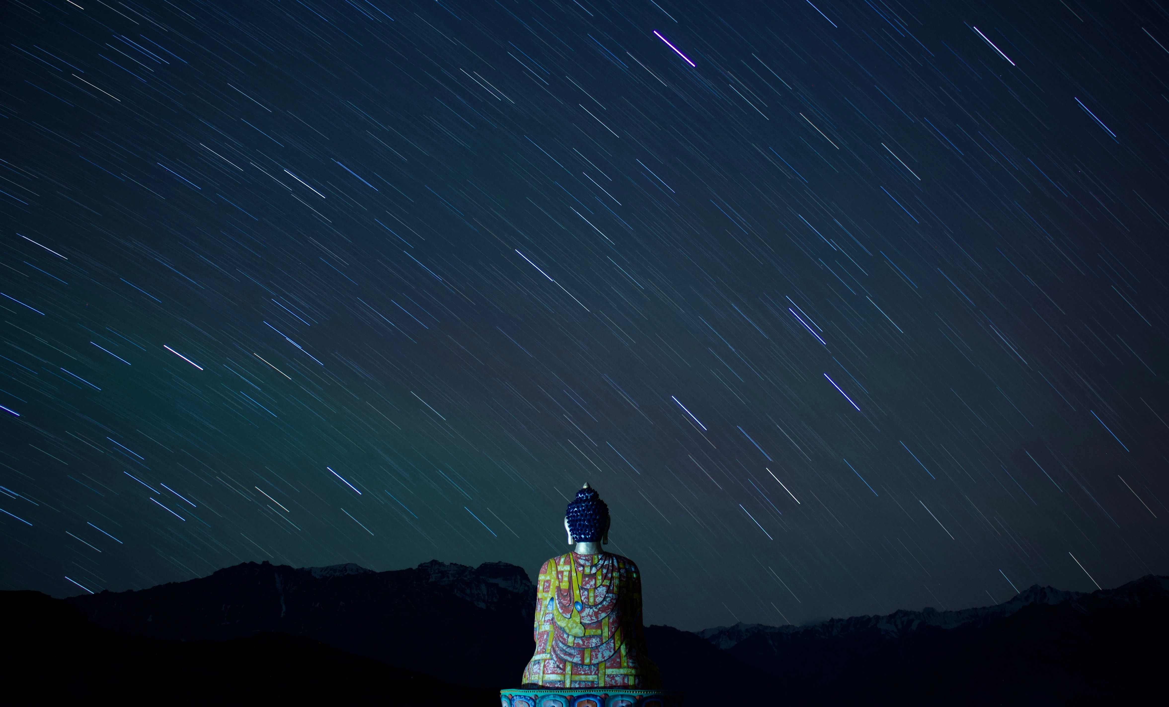 Buddha Statue Under Night Star Trails
