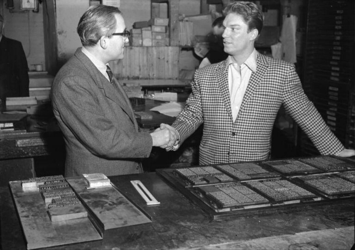 Two Men Shake Hands At Print Workshop
