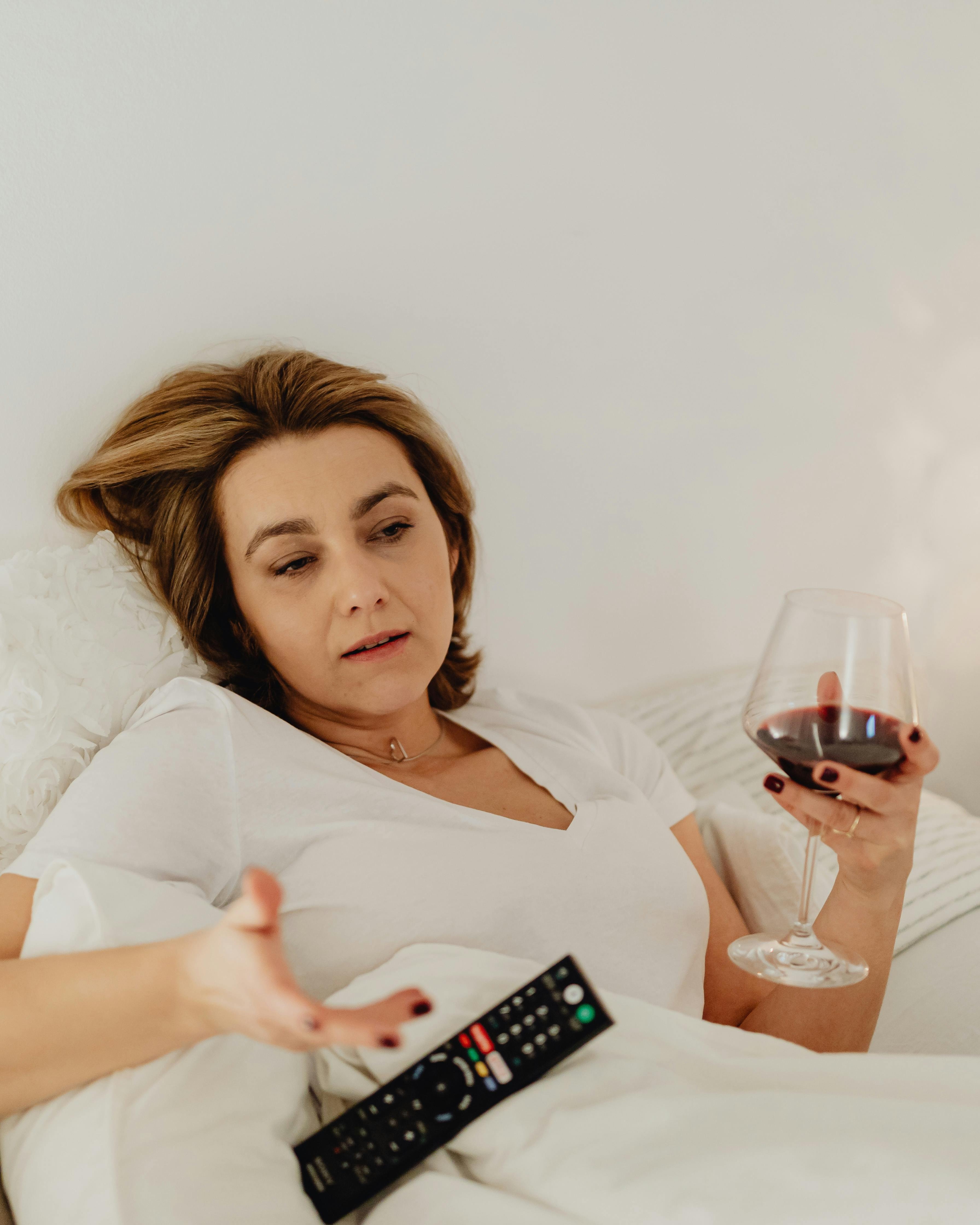 Woman Relaxing With Wine in Bed
