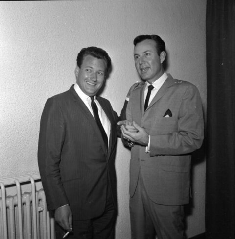 Two Men In Suits Posing Indoors