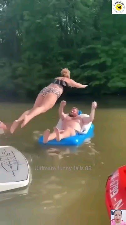 Woman Jumping Into Lake Over Man on Raft