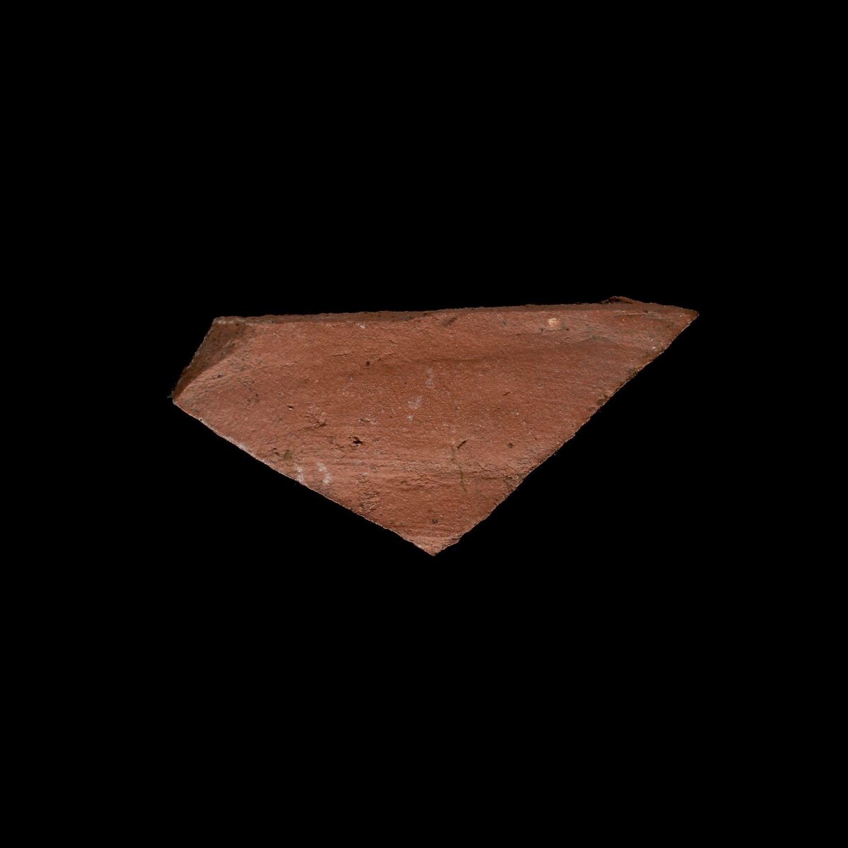 Triangular Red Rock Fragment on Black Background