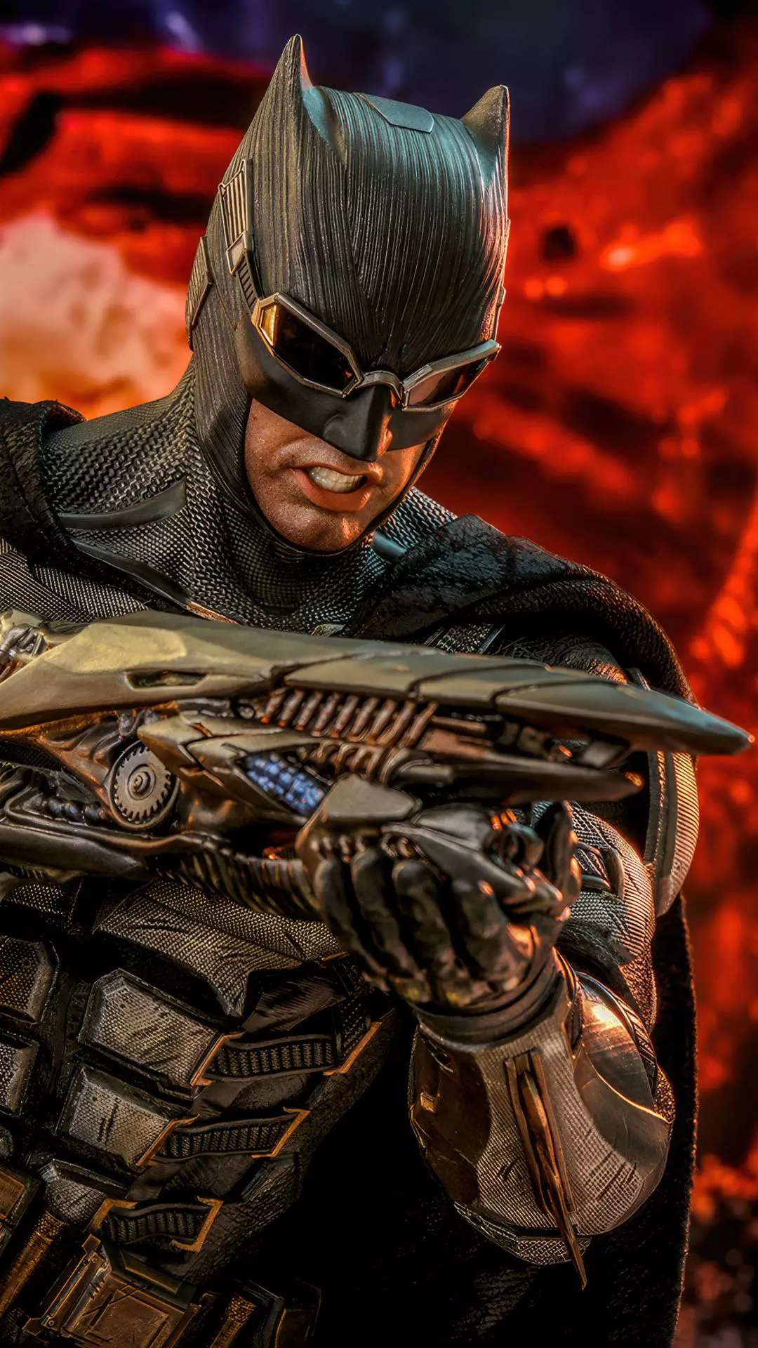 Batman Holding Mechanical Weapon