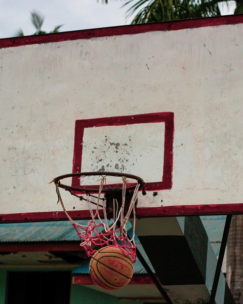 Basketball Passing Through Outdoor Hoop