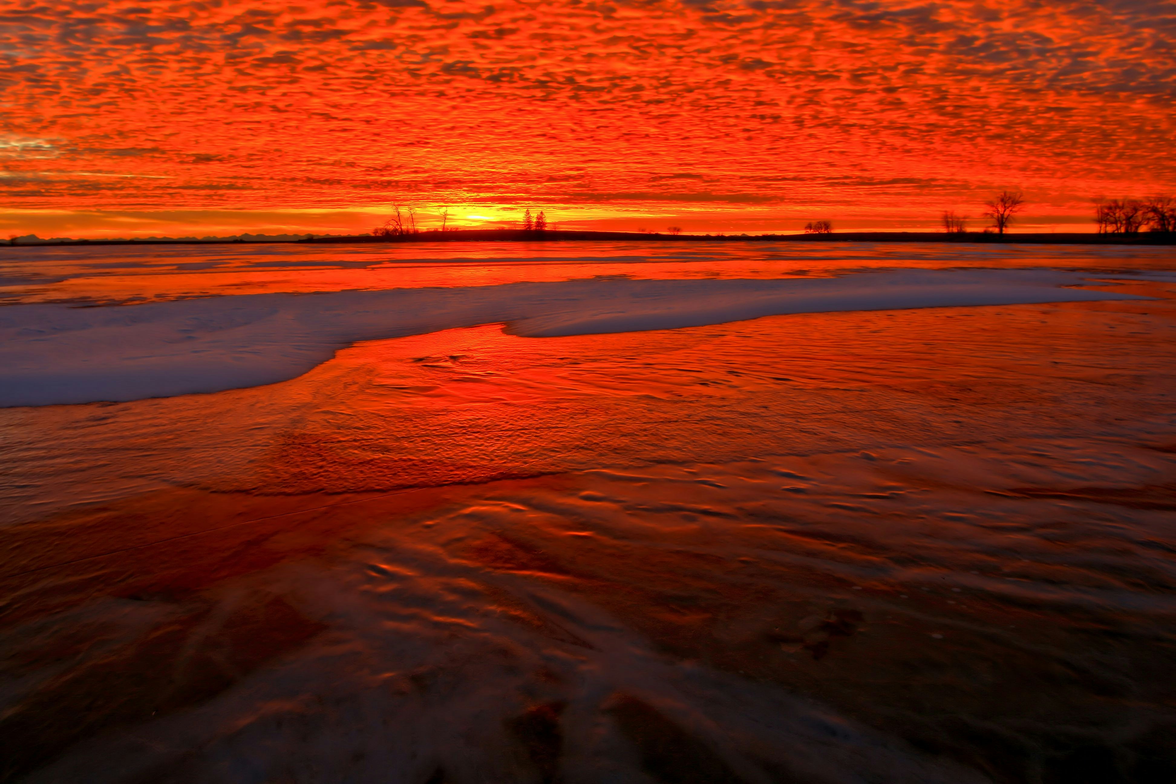 Red Sunset Over Frozen Lake