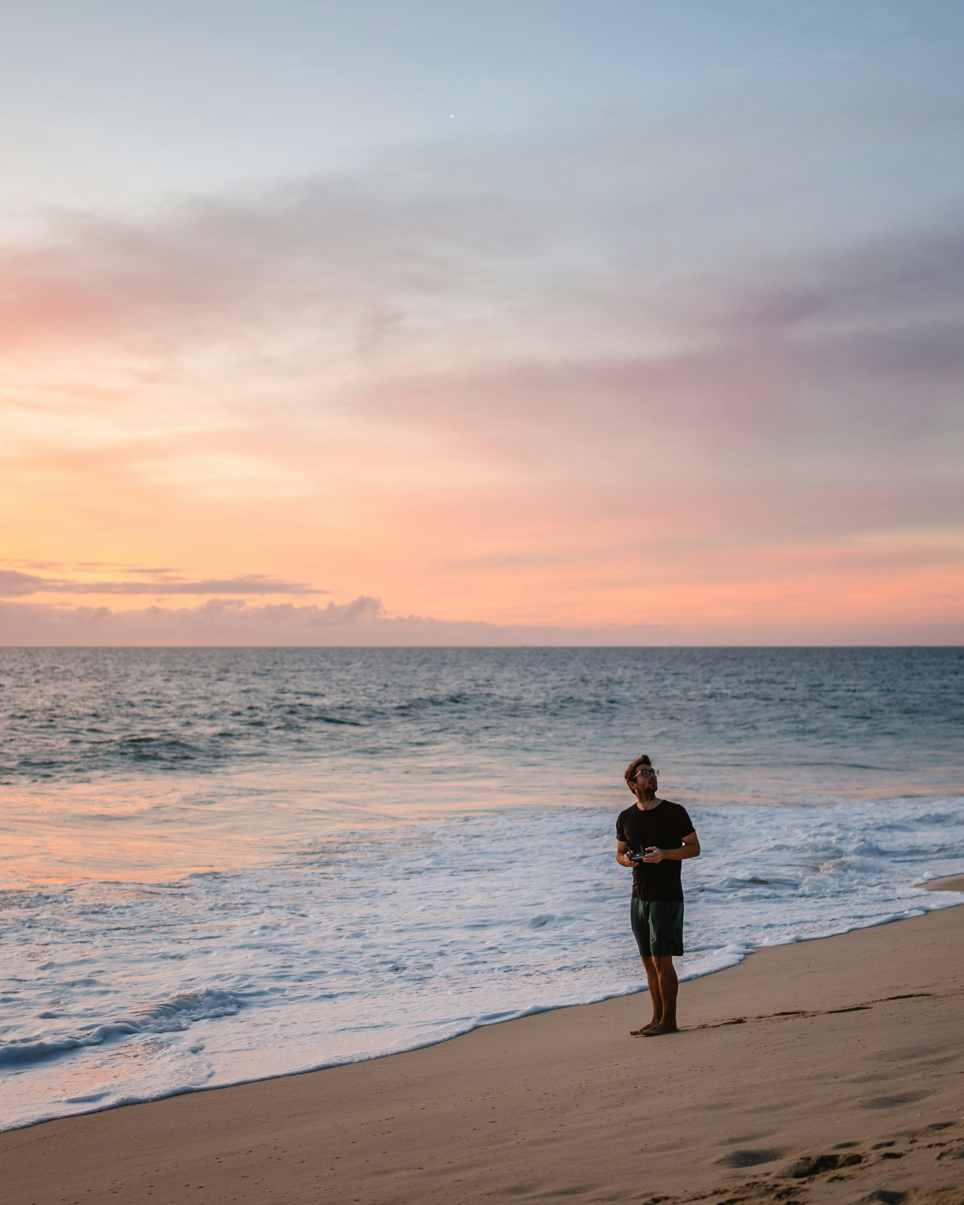Man Flying Drone At Beach Sunset