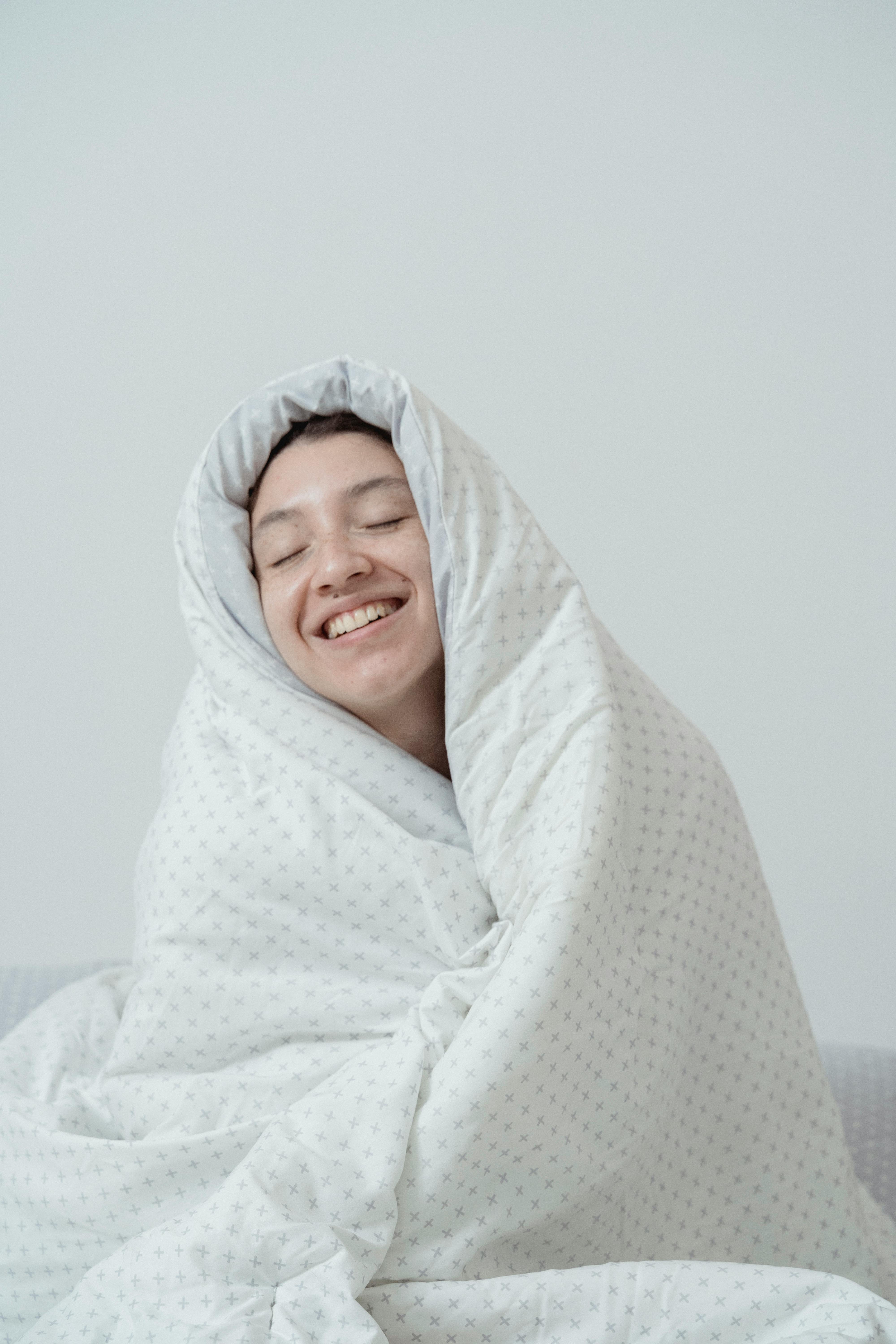 Smiling Woman Wrapped In Blanket