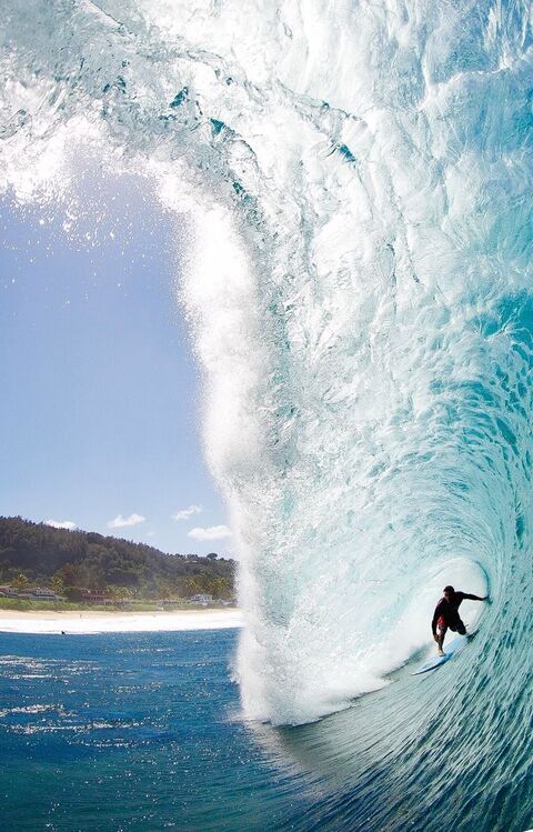 Surfer Riding Giant Barrel Wave