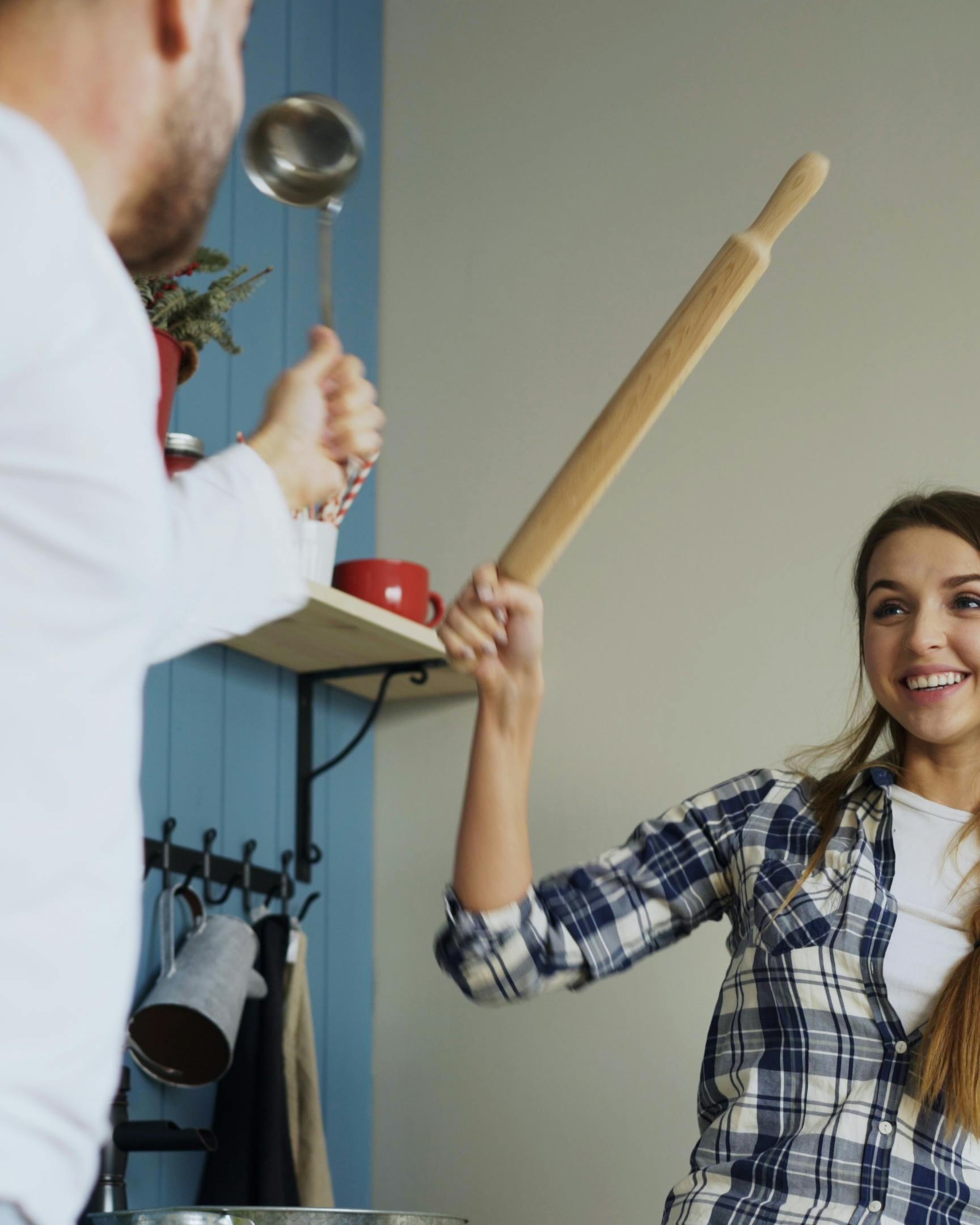 Couple Play Fighting With Kitchen Tools