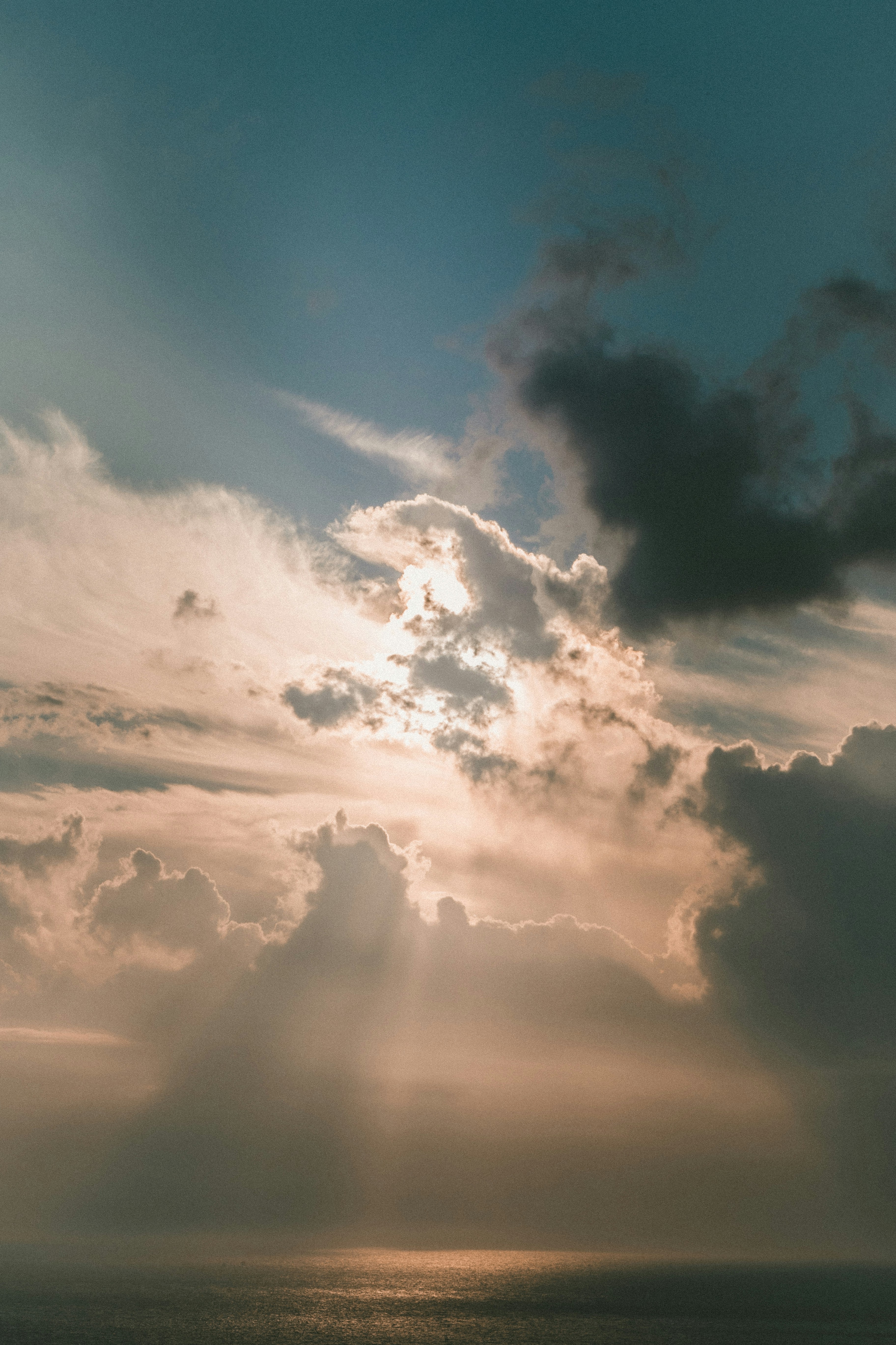 Sunlight Through Clouds Over Sea