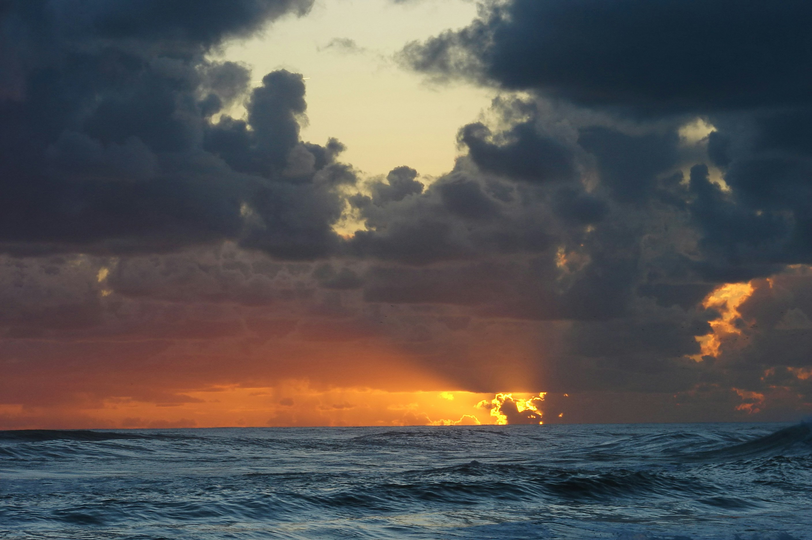 Sunset over Wavy Ocean