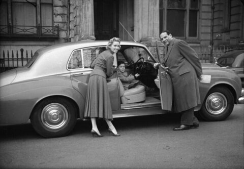 Family Posing With Vintage Luxury Car