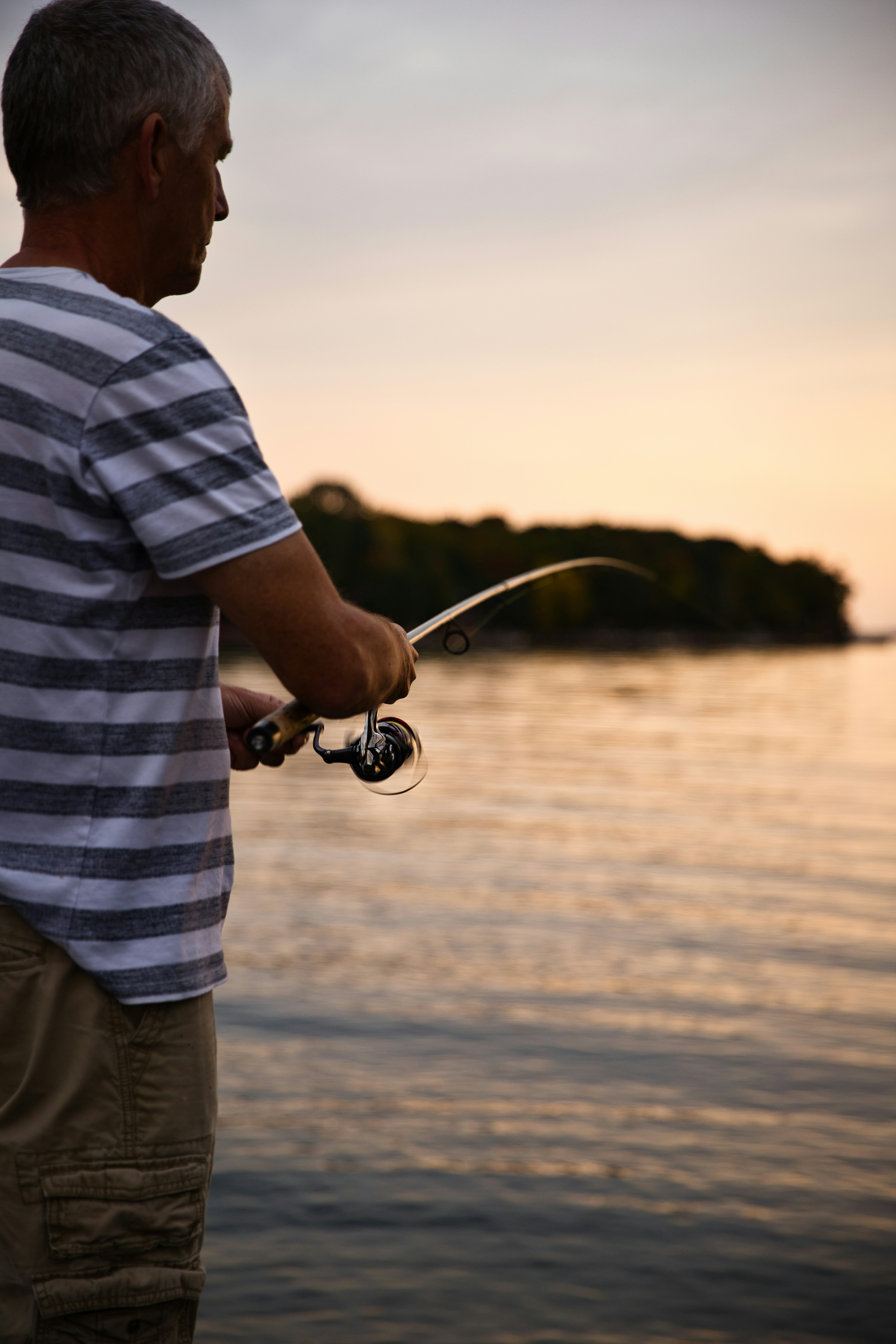 Man Fishing on Lake at Sunset