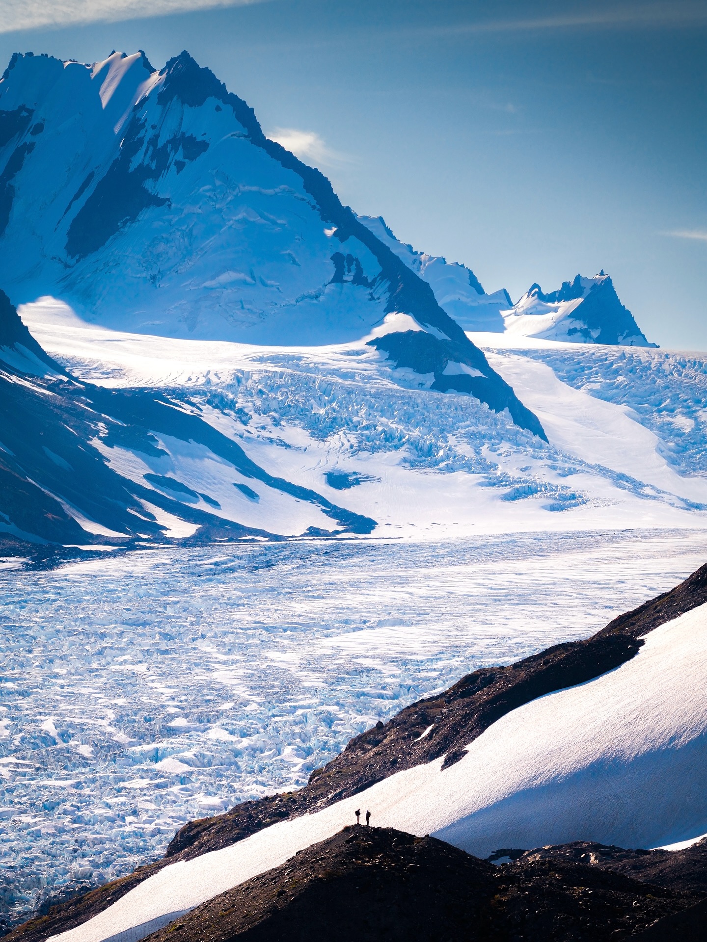 Glacial Mountain Landscape With Hikers