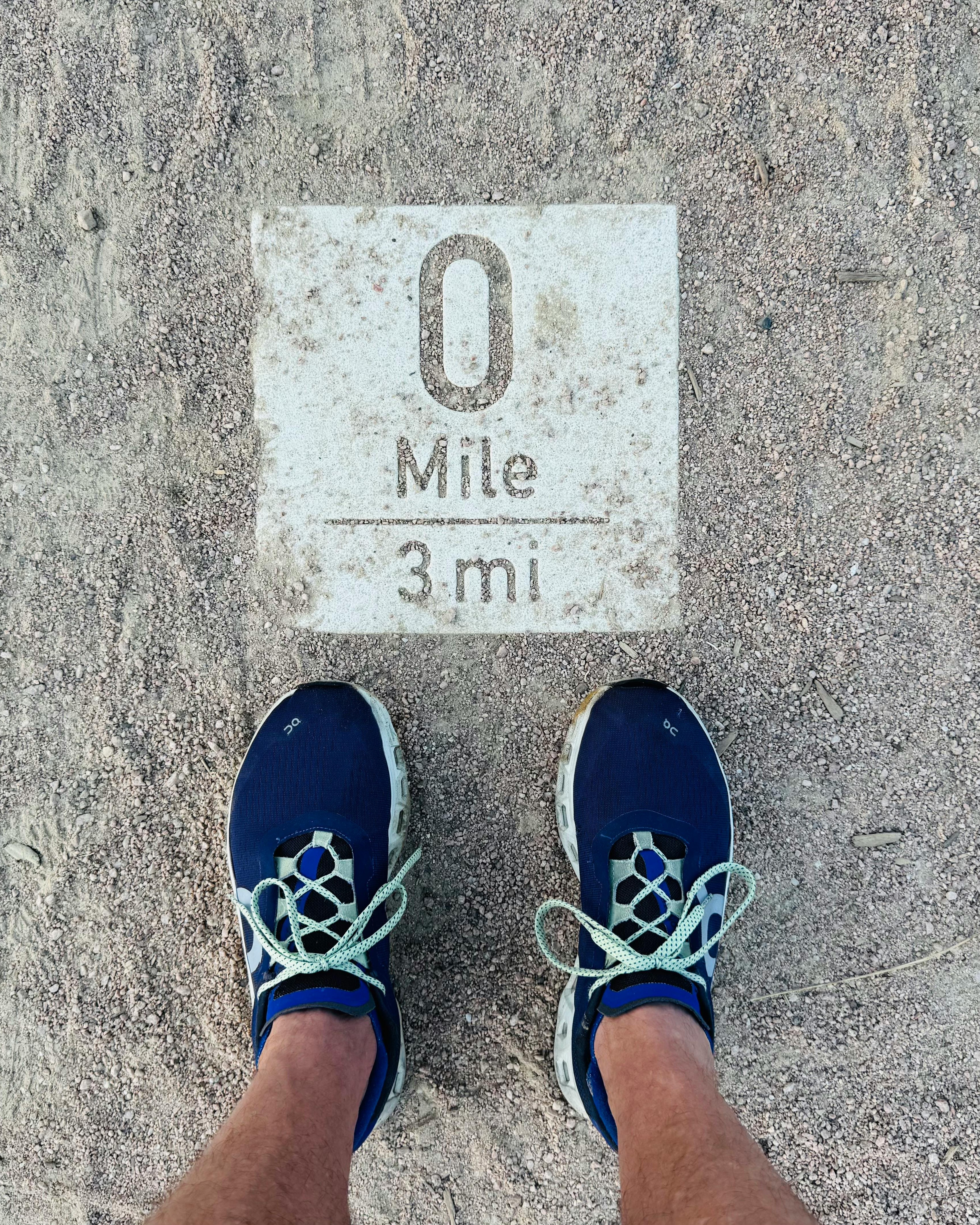 Runner At 0 Mile Trail Marker
