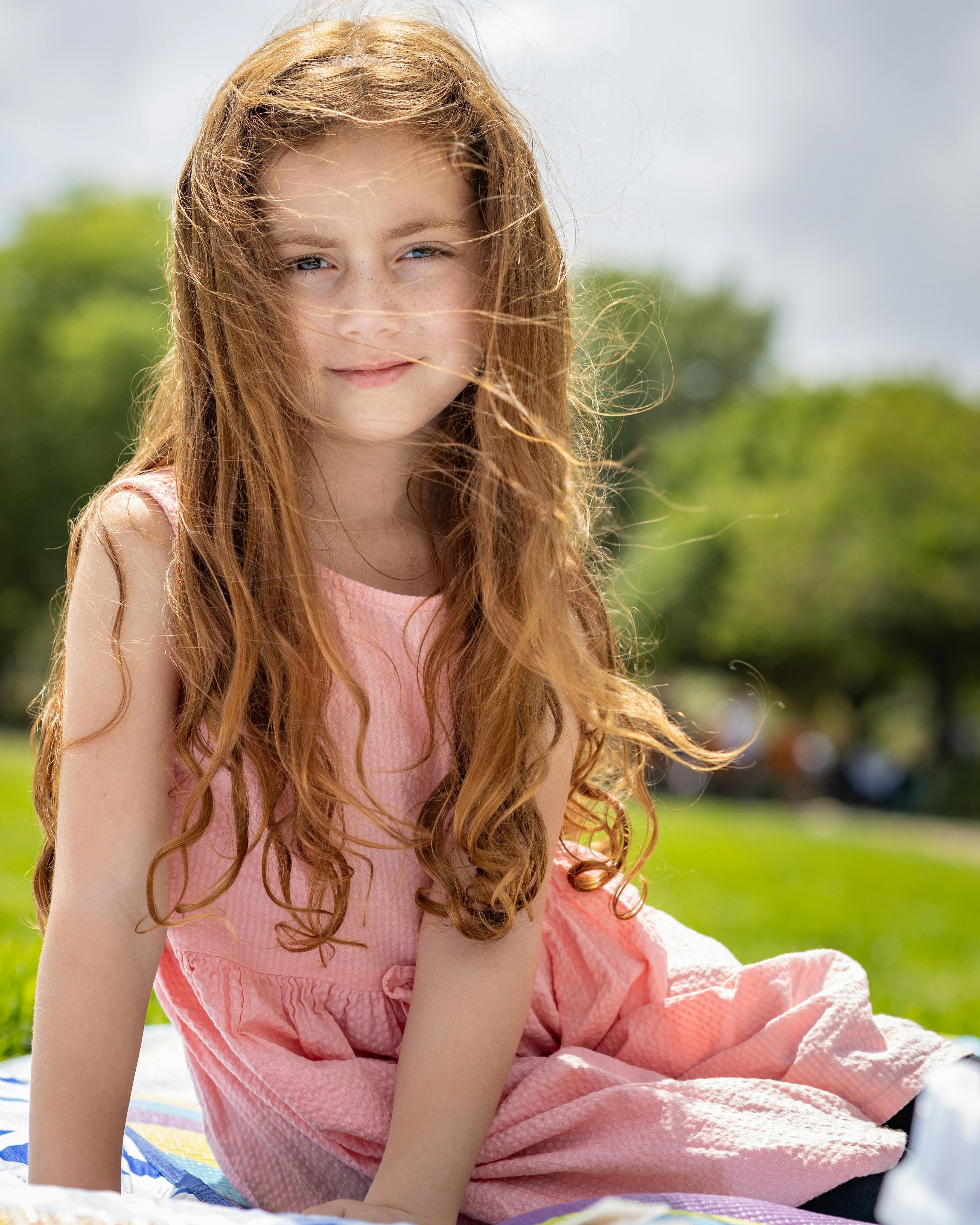 Young Red-haired Girl in Sunny Park