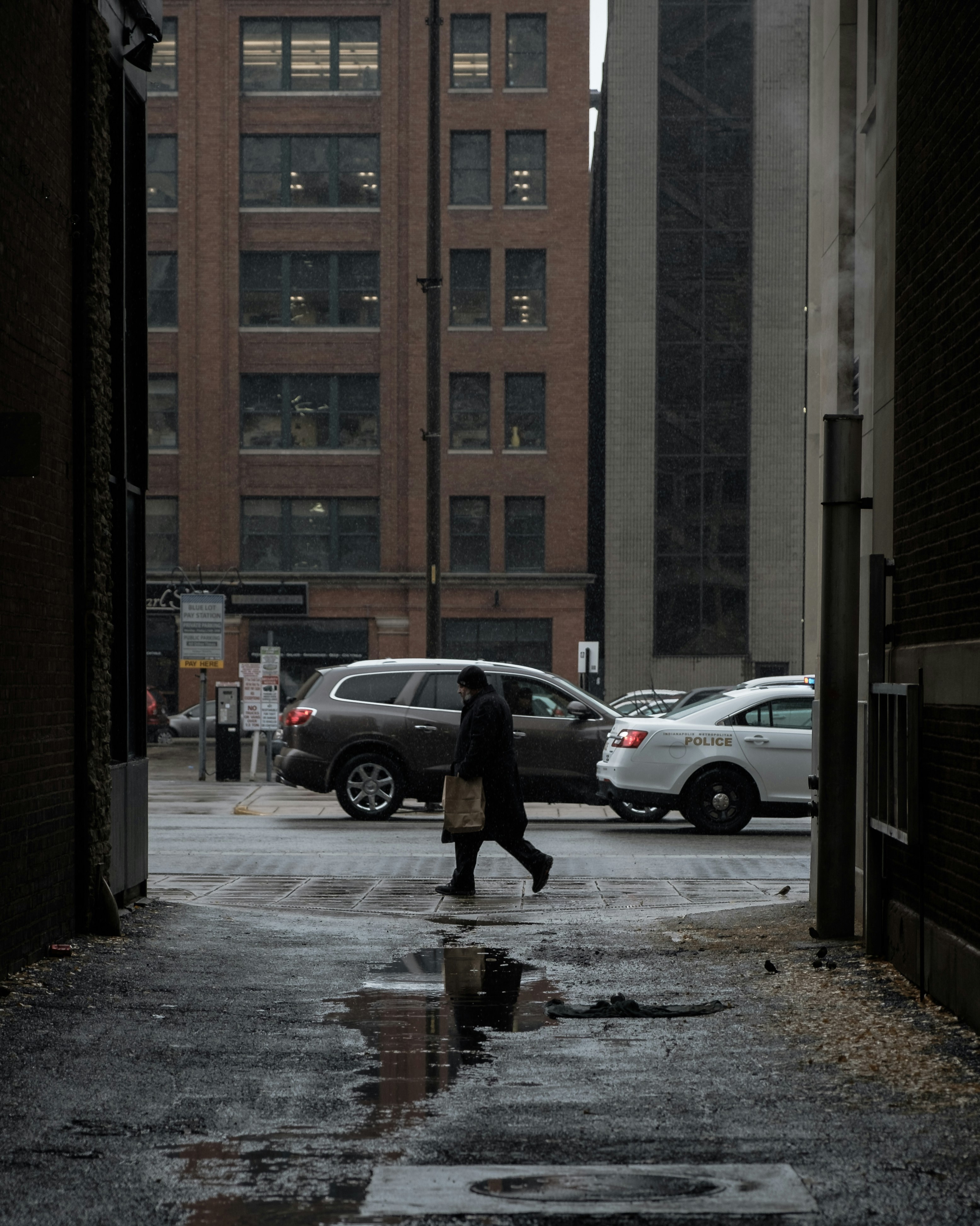 Pedestrian Walking on Rainy Urban Street