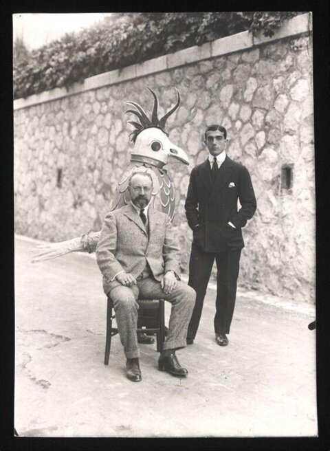 Two Men With Giant Bird Prop