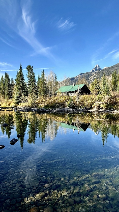Log Cabin Reflected in Mountain River