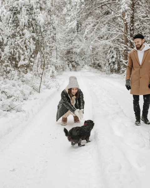 Couple and Dog on Snowy Forest Path
