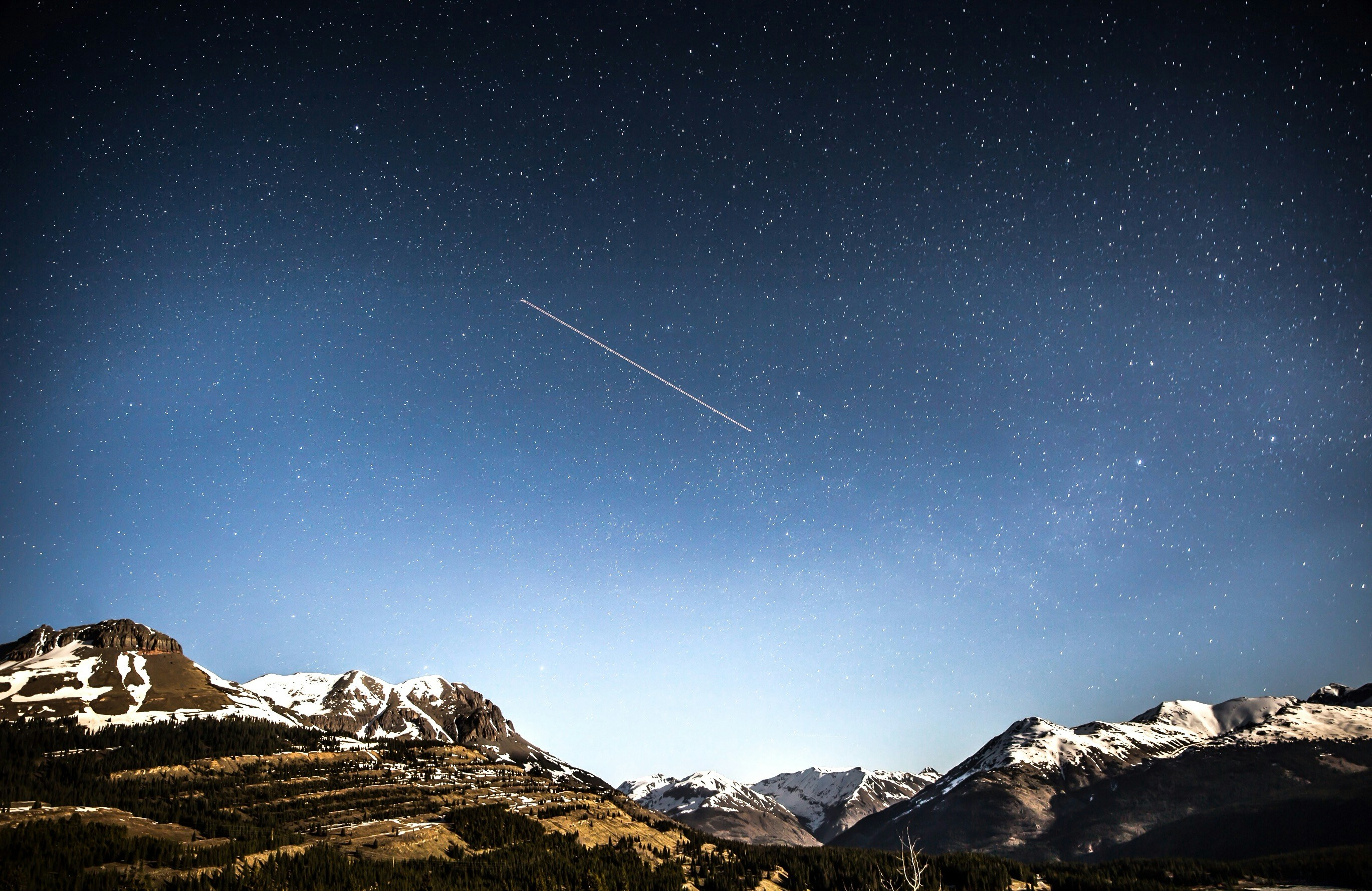 Meteor Over Snowy Mountain Night Sky